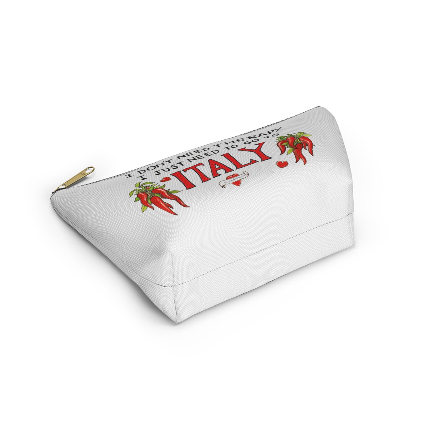 Italy inspired white canvas clutch with the quote I don't need therapy, I just need to go to Italy. The quote is in handwritten with the word Italy in red. On both sides of Italy there are bundles of peppers. The clutch has a black zipper that fits with the black text. Designed by Italian Summers
