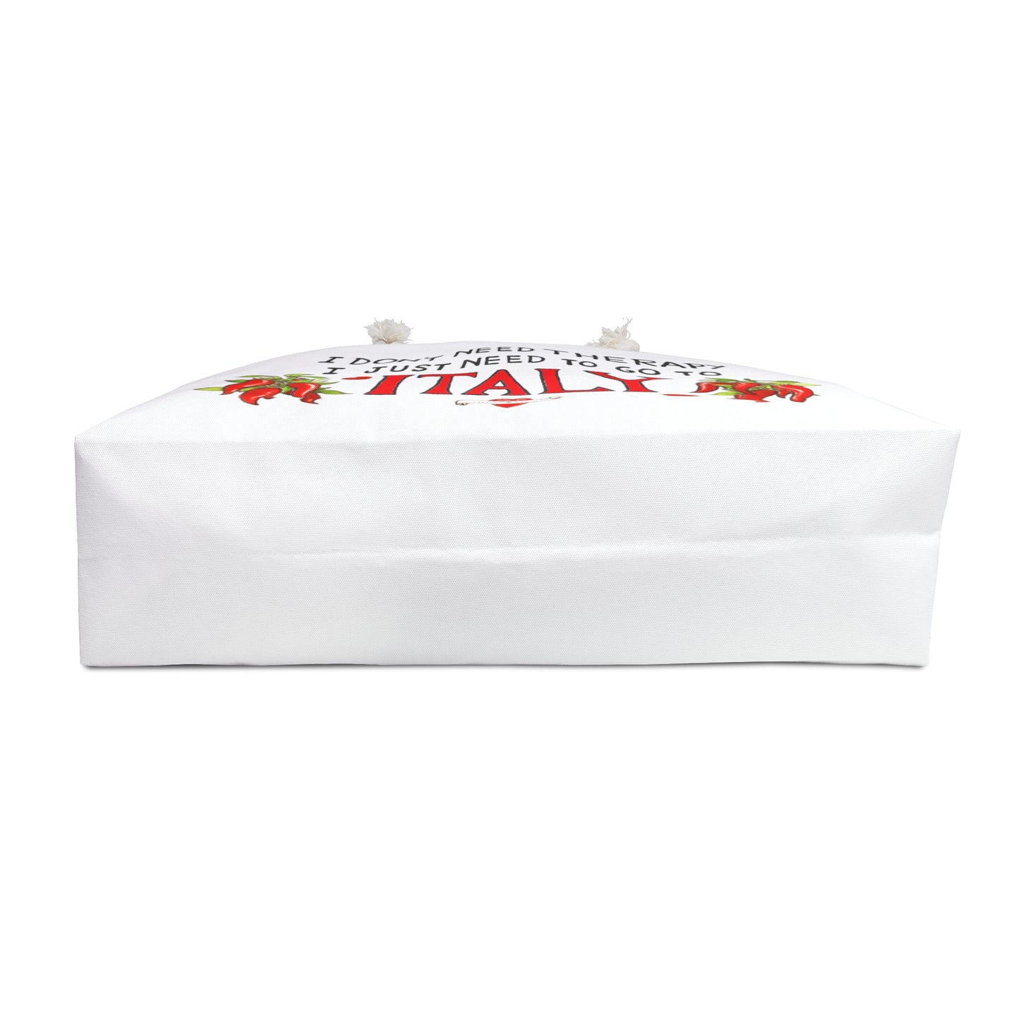 Italy inspired beach bag with the quote I don't need therapy, I just need to go to Italy. The quote is in black hand writing the word Italy is in the color red. On both sides of Italy there is a bunch of peppers. The bag has soft rope handles