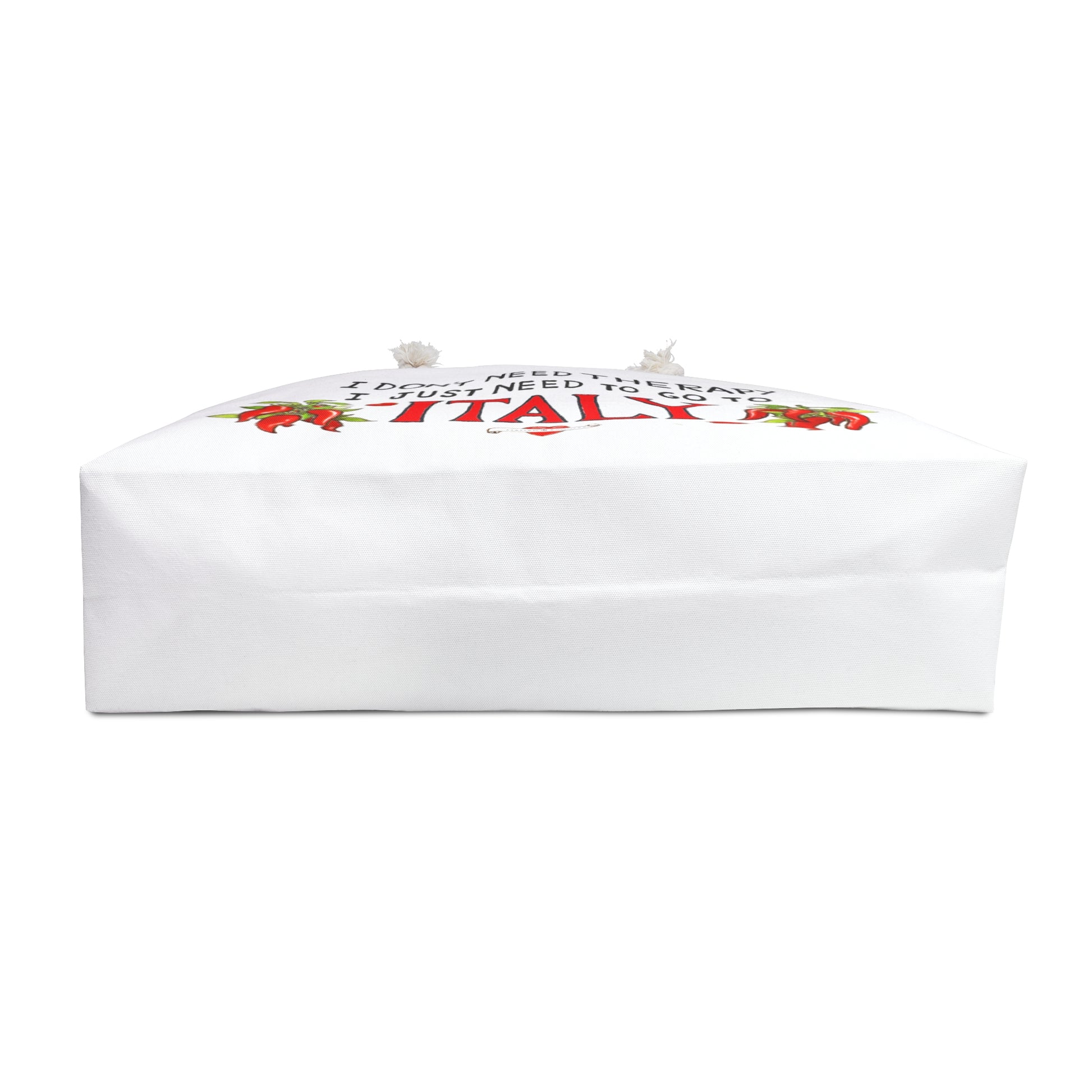 Italy inspired beach bag with the quote I don't need therapy, I just need to go to Italy. The quote is in black hand writing the word Italy is in the color red. On both sides of Italy there is a bunch of peppers. The bag has soft rope handles