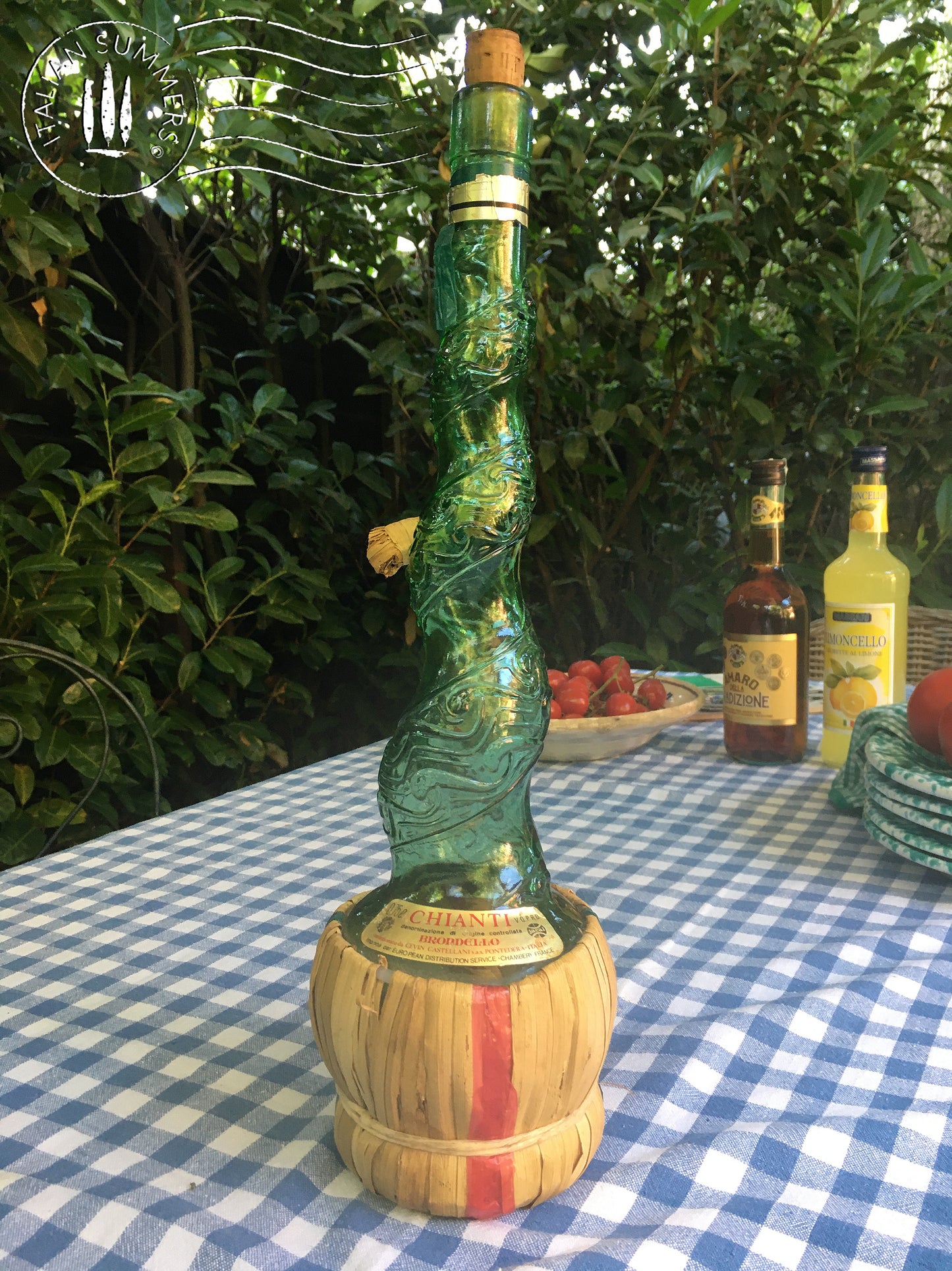 Empoli Genie Bottle, Chianti wicker glass flask, A beautiful Italian vintage wine decanter from the 1950s-60s. Emerald green glass and a spiraling floral embossing along the bottle's convoluted profile.  true find