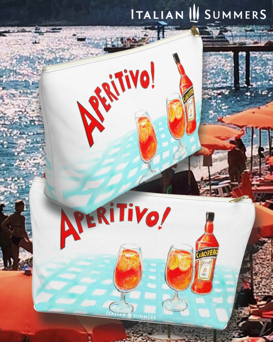 Italy inspired clutch of white canvas with the writing Aperitivo in red and a sketch of a vage lightblue checkered table cloth with on top a bottle of Aperol, which we called Ciaoperol and two glasses filled with Spritz and ice cubes. Designed by Italian Summers.