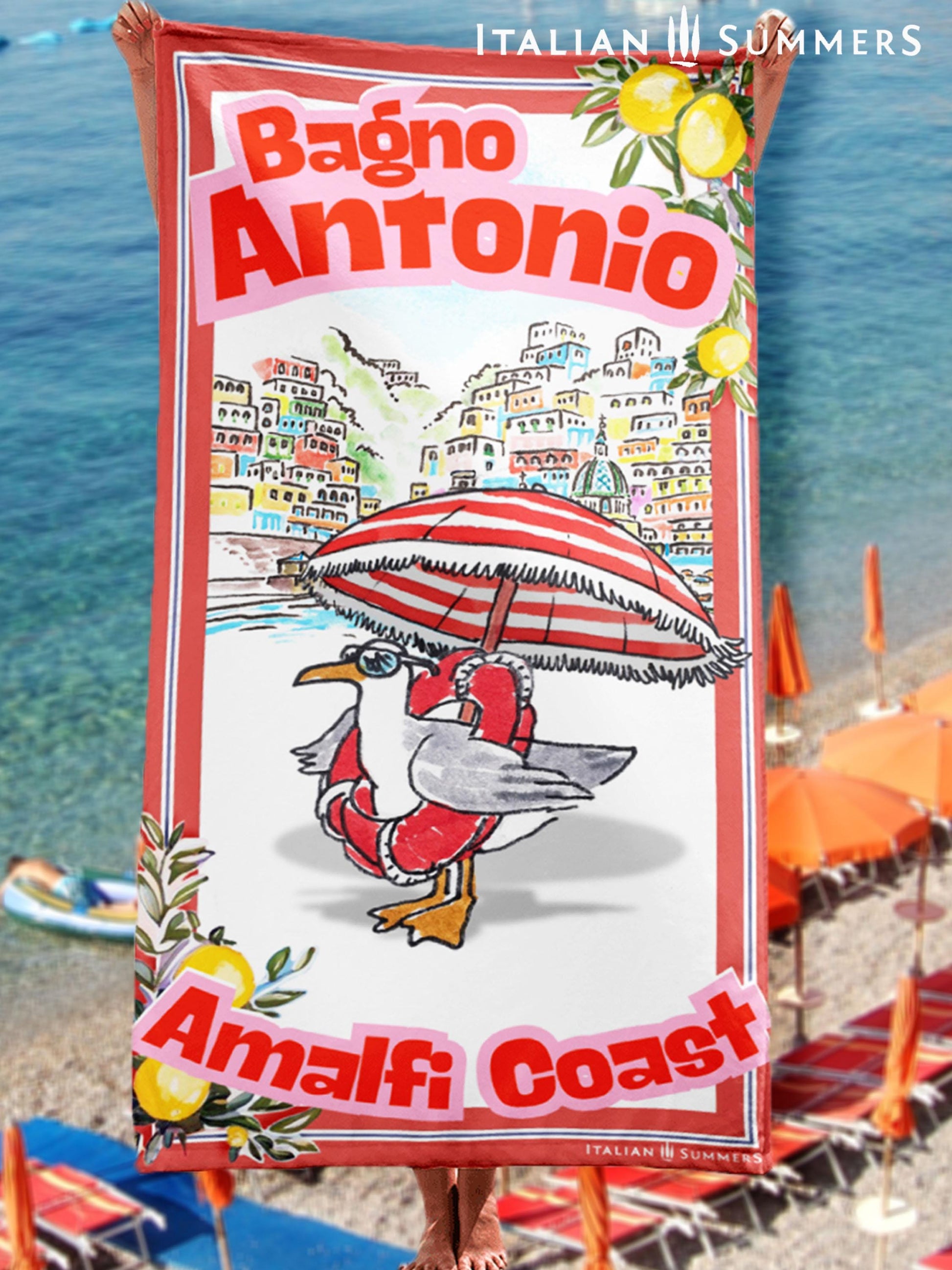 Illustrated Amalfi Coast beach towel featuring a funny seagull wearing sunglasses and a life saver while standing under a striped beach umbrella, Positano in the background, and vintage lemon borders with the text Bagno Antonio and Amalfi Coast Designed by Italian Summers