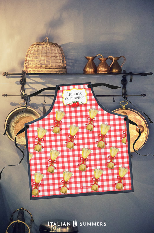 A happy red-checkered printed pattern apron with bundles of spaghetti with red bows . On the chest is a yellow  gold frame with the text: Italians do it better, and two happy tomatoes with an Italian  flag