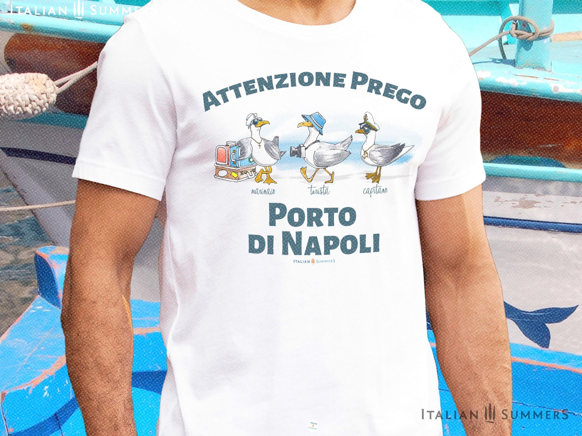 A cotton T-Shirt with the Italian text PORTO di NAPOLI in blue block letters and featuring the hand-drawn sketches of  three seagulls dressed up as a sailor, a tourist, and a boat captain.