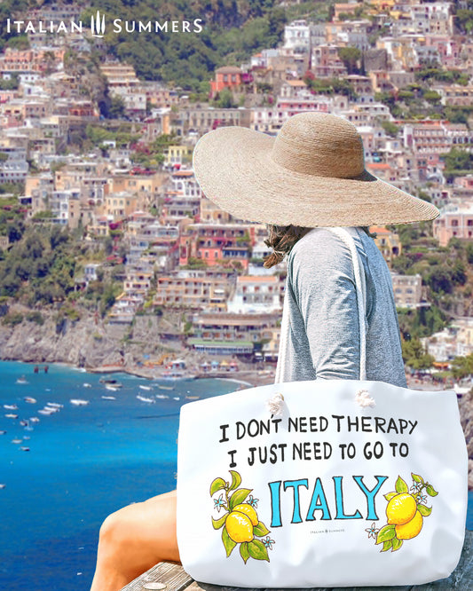 Italy inspired large beach bag with the quote I don't need therapy, I just need to go to Italy, with Italy in a blue hand writing. The Italy writing is decorated wirh amalfi Coast lemons on both sides. The beach bag has rope handles