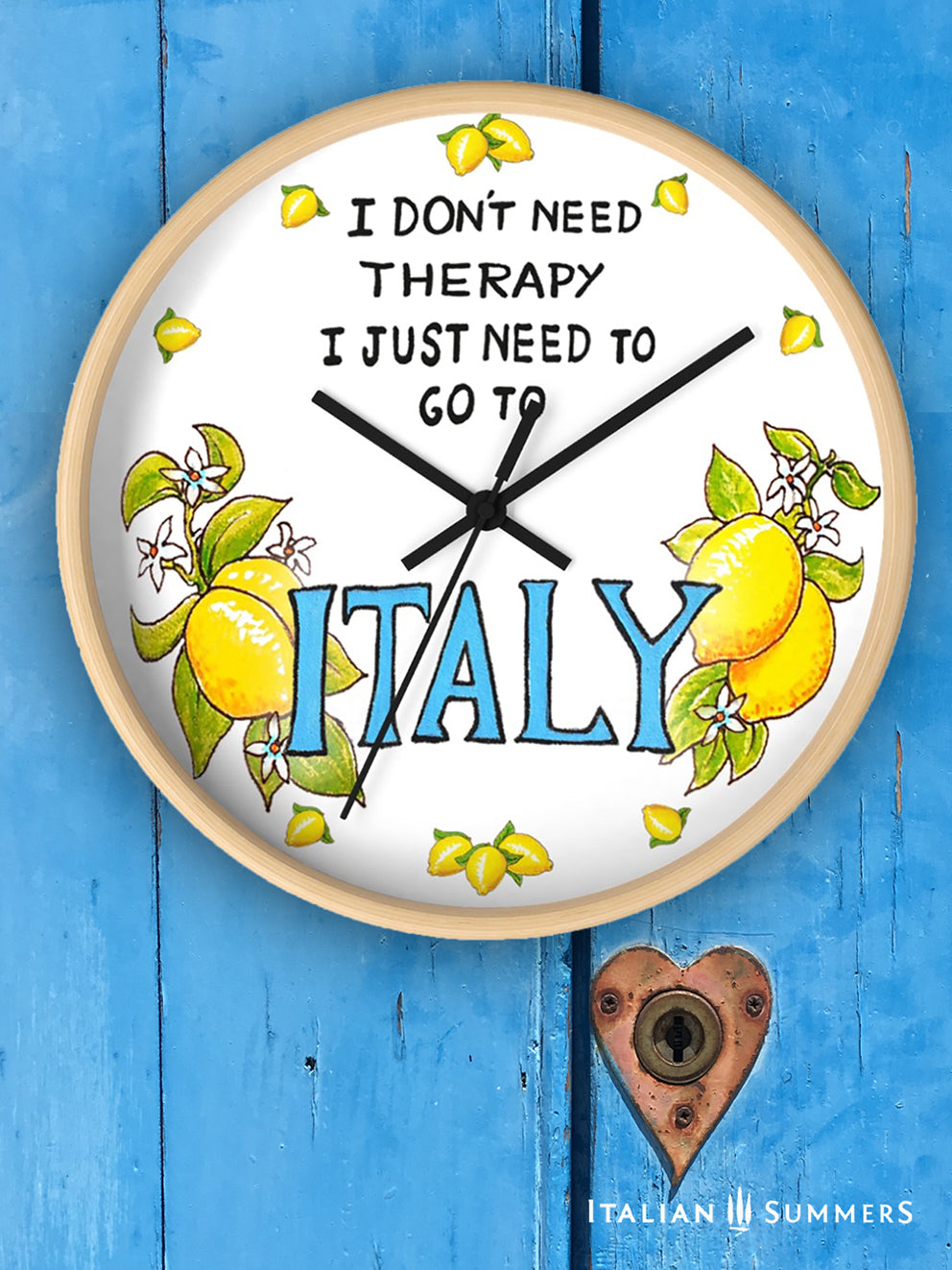 Italy inspired wall clock with the quote "I don't need therapy, I just need to go to Italy" . The quote is in the top center of the clock in balck handriting. In the lower part of the clock there is Italy written in big blue letter with on both sides a bundle of lemons with flowers. In stead of numbers there are little lemons. The body if the clock is available in wood color and white. The hands color is available in white and black. Made by Italian Summers.