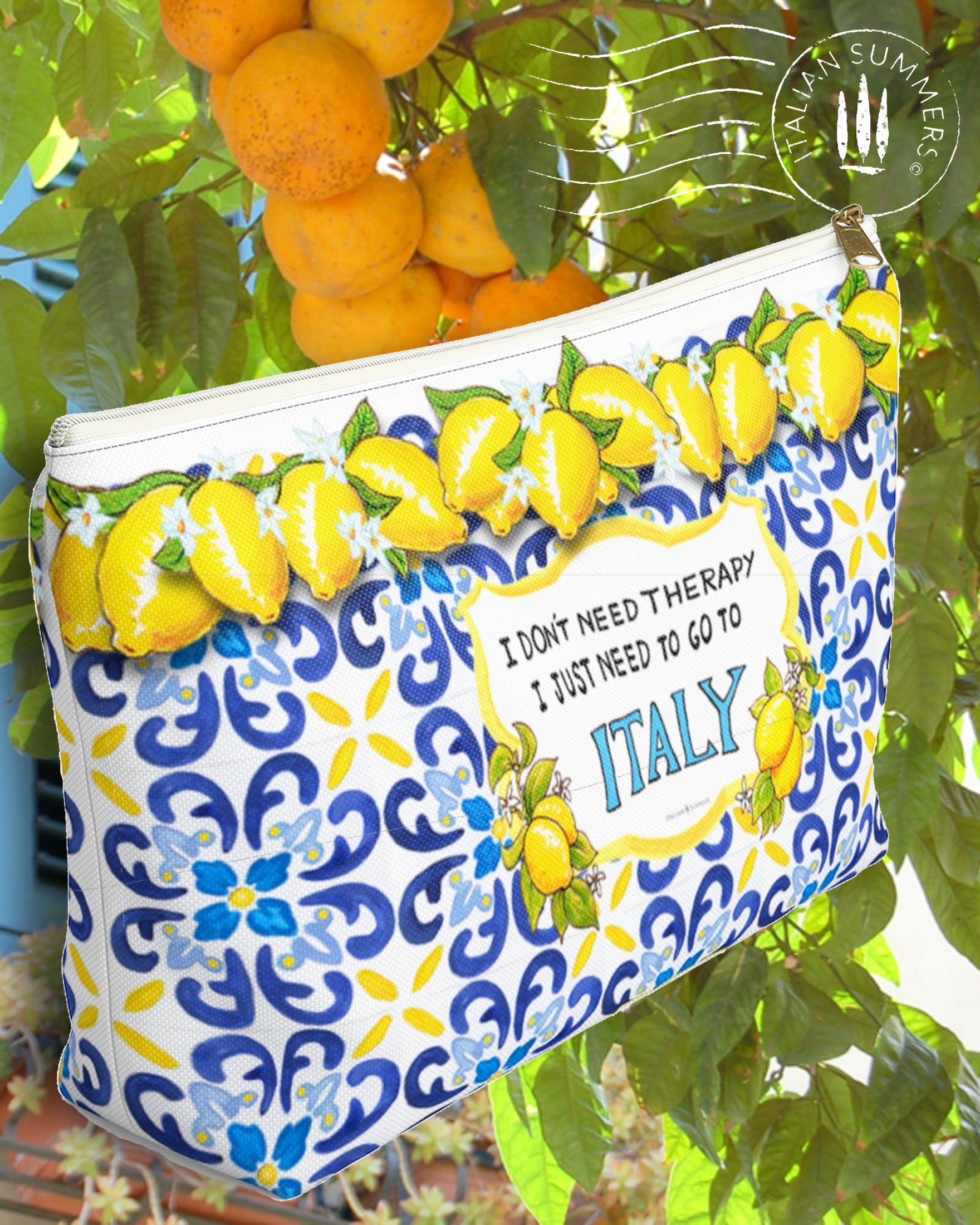 Italy inspired Clutch with  Lemons and blue Italian  Tiles  with the quote I don't need Therapy I just need to go to Italy in the front center  inside a crest with flanking Sorrento lemons with flowers. Made by Italian Summers