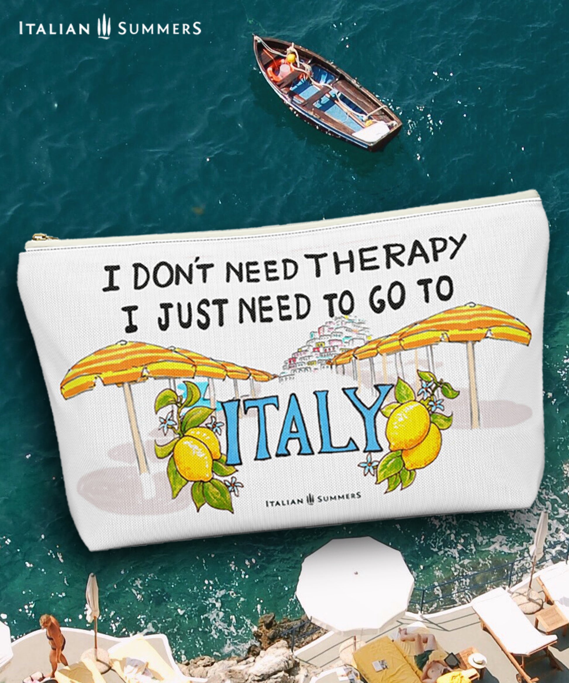 Italy inspired clutch of white canvas with he quote I don't need therapy, I just need to go to Italy. On the clutch there is a sketch of the beach umbrellas on Positano beach The beach umbrellas are yellow and orange striped. In the distance you ccan see the stagered houses of Positano. The word Italy in in big blue letters and is flancked with lemons. Designed by Italian Summers.