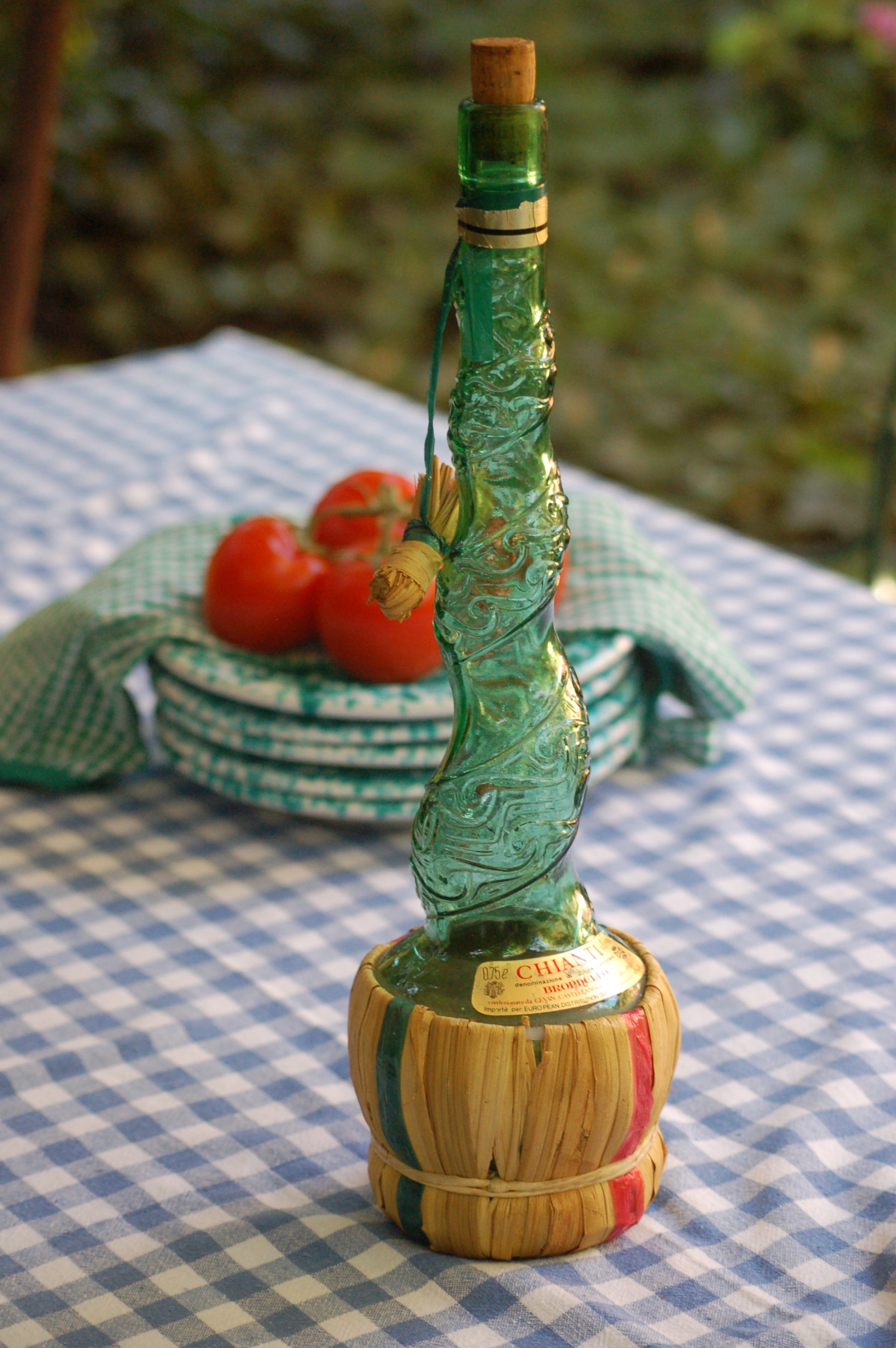 Empoli Genie Bottle, Chianti wicker glass flask, A beautiful Italian vintage wine decanter from the 1950s-60s. Emerald green glass and a spiraling floral embossing along the bottle's convoluted profile.  true find