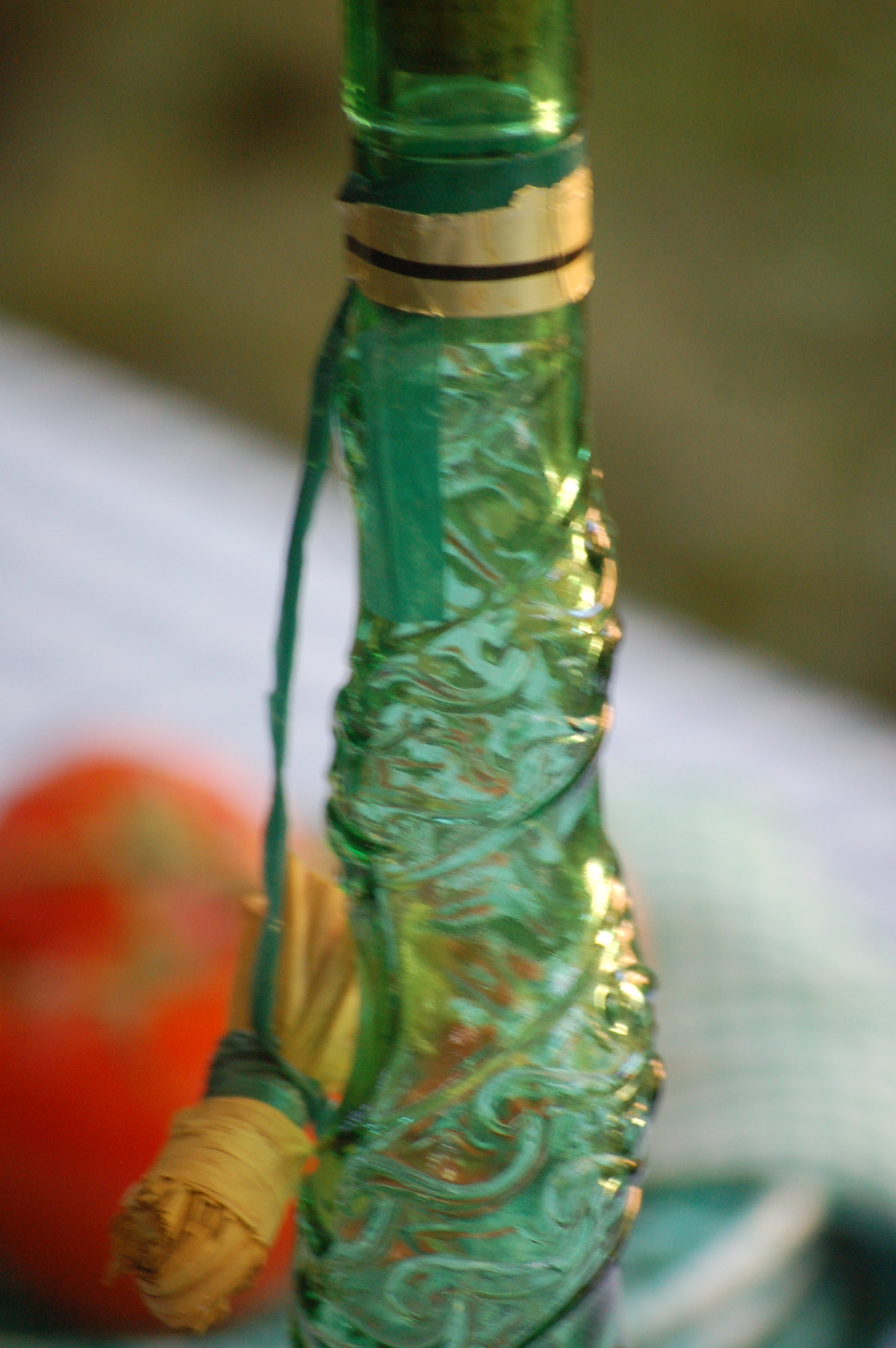 Empoli Genie Bottle, Chianti wicker glass flask, A beautiful Italian vintage wine decanter from the 1950s-60s. Emerald green glass and a spiraling floral embossing along the bottle's convoluted profile.  true find