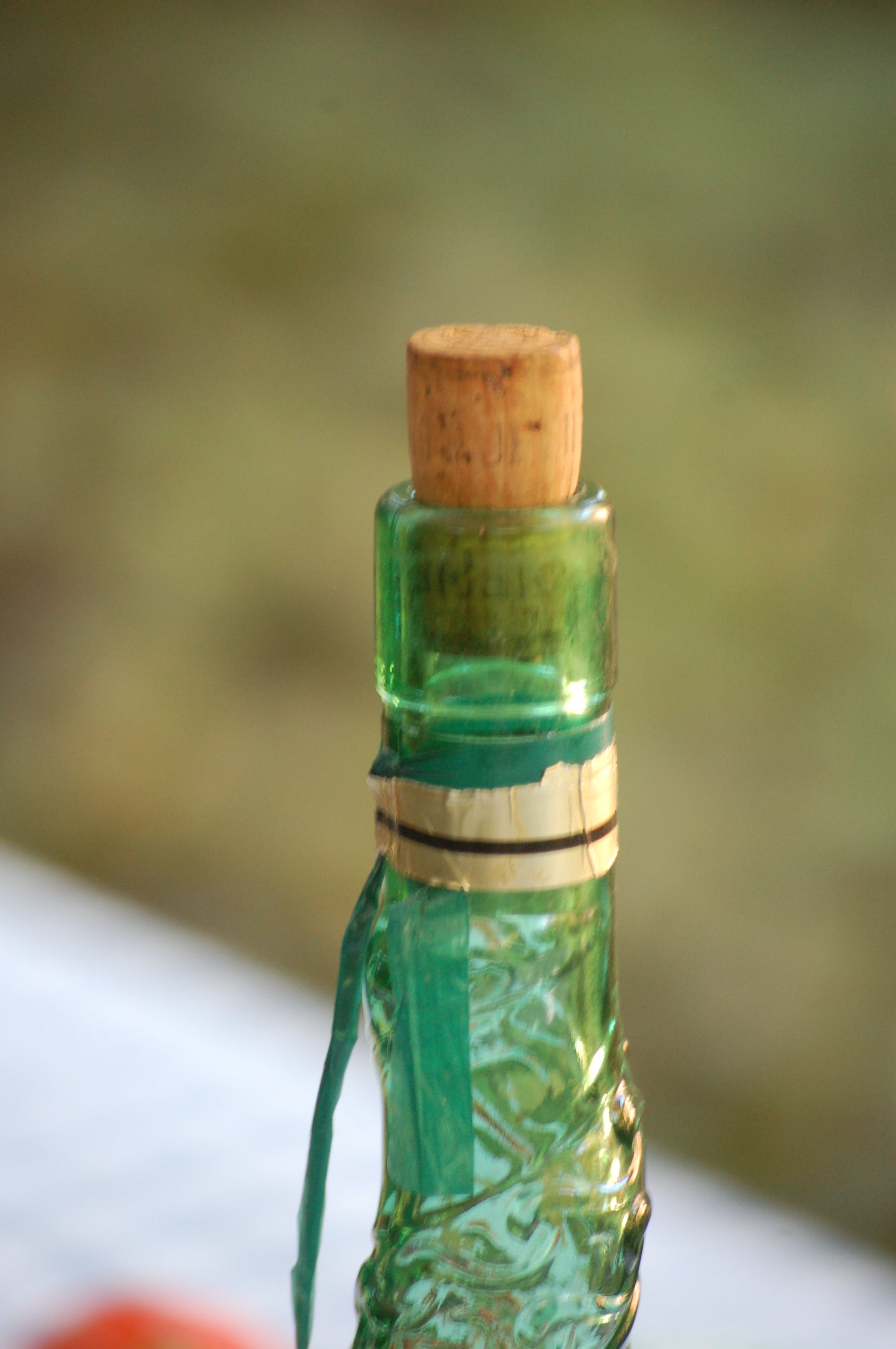 Empoli Genie Bottle, Chianti wicker glass flask, A beautiful Italian vintage wine decanter from the 1950s-60s. Emerald green glass and a spiraling floral embossing along the bottle's convoluted profile.  true find