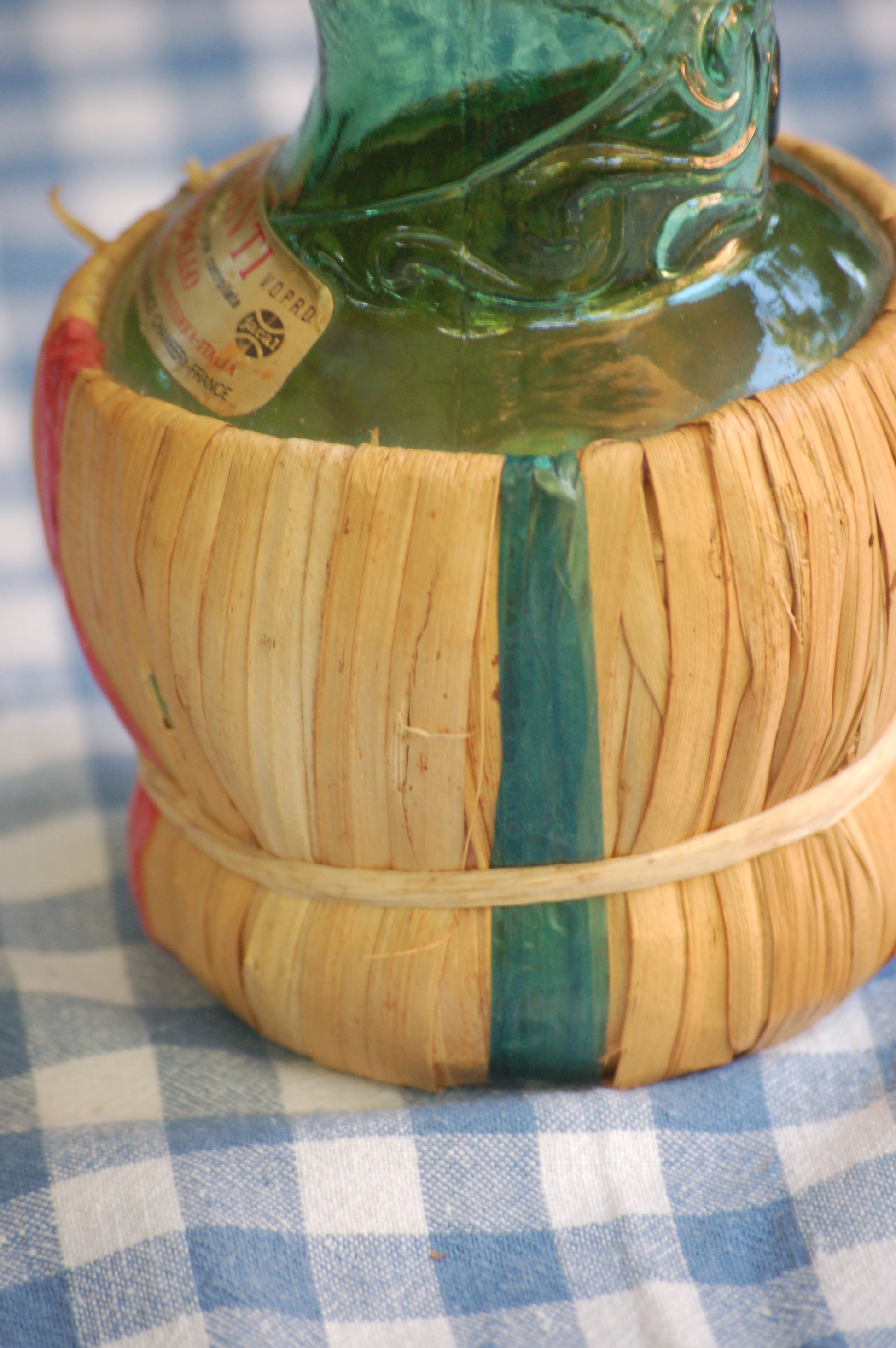 Empoli Genie Bottle, Chianti wicker glass flask, A beautiful Italian vintage wine decanter from the 1950s-60s. Emerald green glass and a spiraling floral embossing along the bottle's convoluted profile.  true find