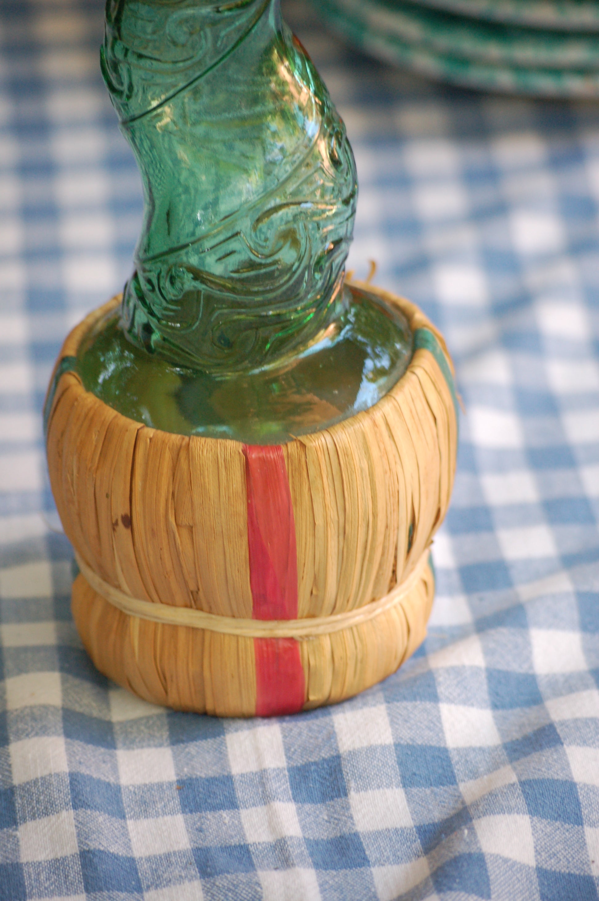 Empoli Genie Bottle, Chianti wicker glass flask, A beautiful Italian vintage wine decanter from the 1950s-60s. Emerald green glass and a spiraling floral embossing along the bottle's convoluted profile.  true find