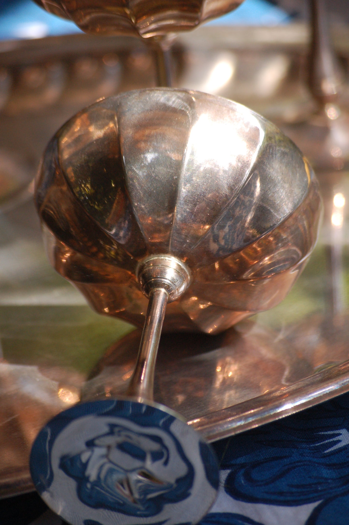 Italian Vintage Champagne coupes.set of six silver and gold plated long stemmed coupes on a silver plated tray upon a table with a flower blue Mediterranean pattern. A bowls with lemons is nearby along with white and blue maiolica serving bowls.,