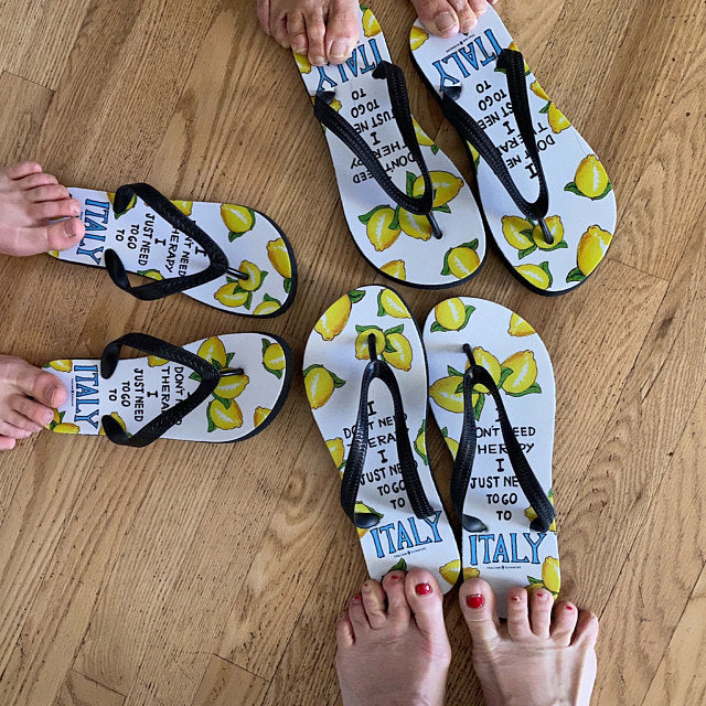 Italy flip flops I don't need therapy, I just want to go to Italy! The cutest flip flops of the beach. White flip flops with blach straps. The white base shows happy Italian lemons with the Italy therapy quote. Made by Italian Summers.