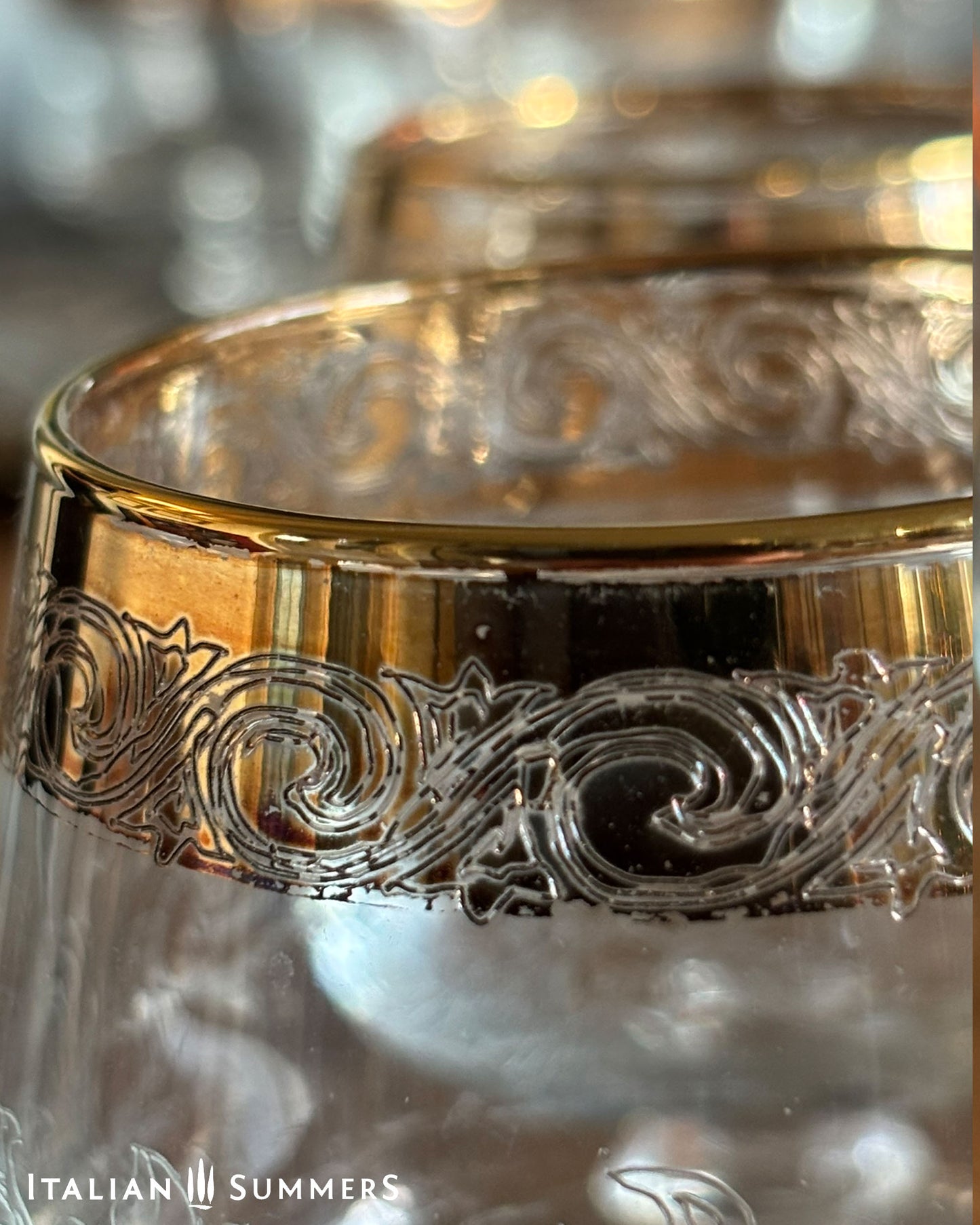 Decorative glass with gold rim and intricate patterns, brand 'Italian Summers' visible.