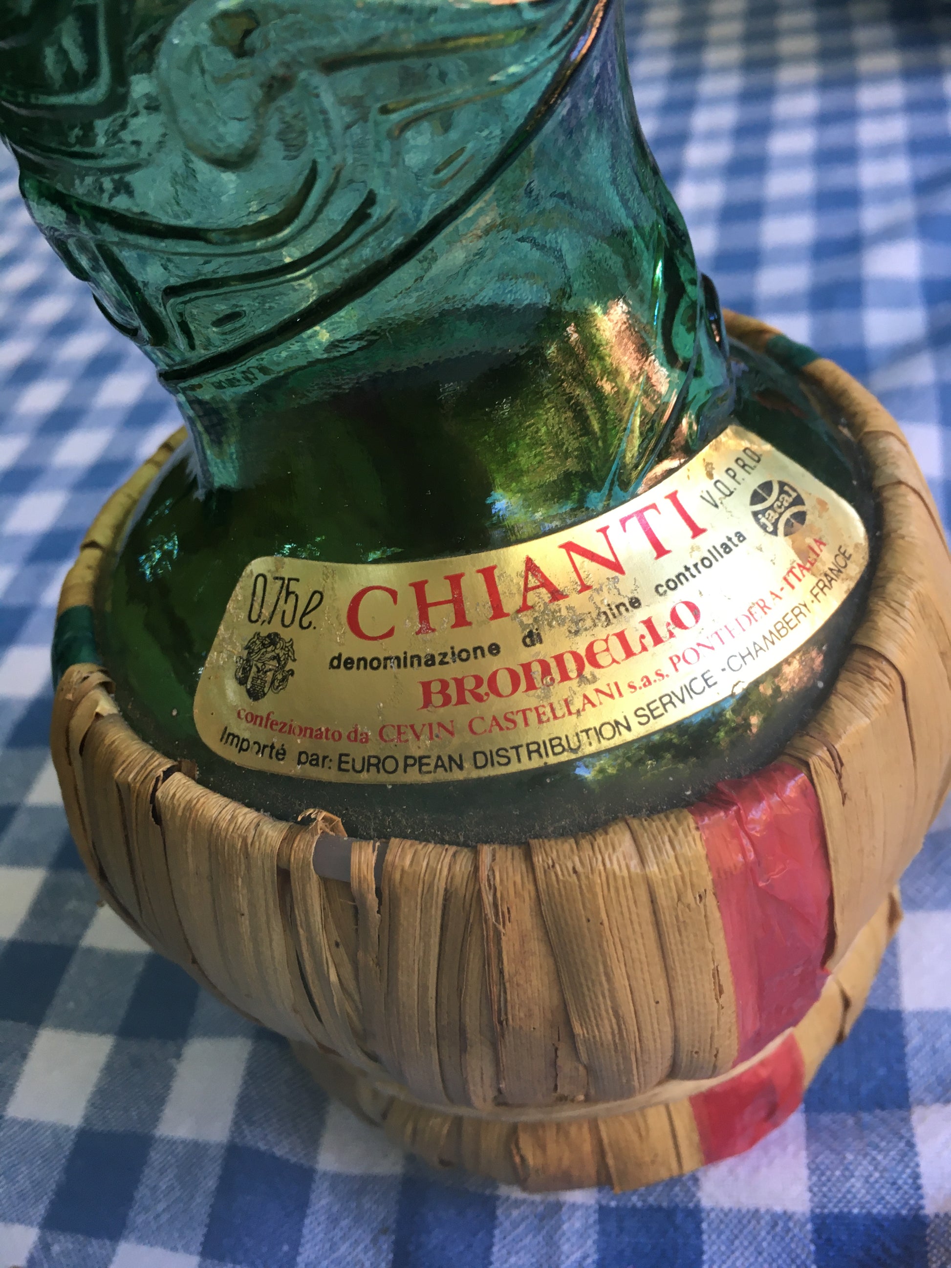 Empoli Genie Bottle, Chianti wicker glass flask, A beautiful Italian vintage wine decanter from the 1950s-60s. Emerald green glass and a spiraling floral embossing along the bottle's convoluted profile.  true find