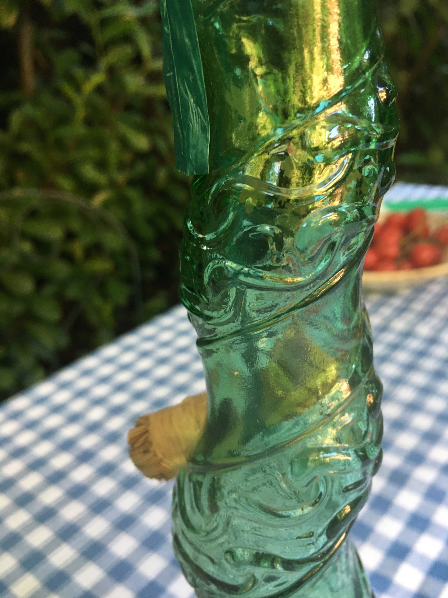 Empoli Genie Bottle, Chianti wicker glass flask, A beautiful Italian vintage wine decanter from the 1950s-60s. Emerald green glass and a spiraling floral embossing along the bottle's convoluted profile. true find