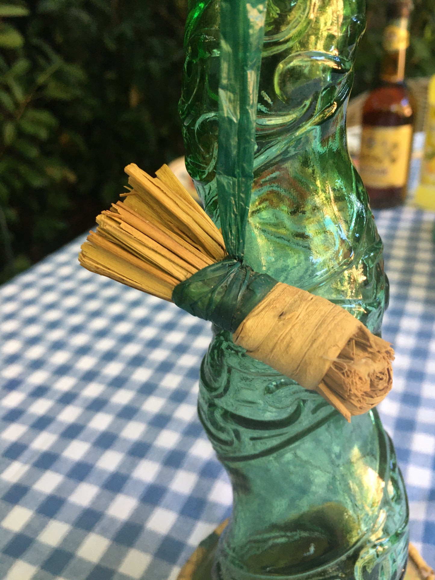 Empoli Genie Bottle, Chianti wicker glass flask, A beautiful Italian vintage wine decanter from the 1950s-60s. Emerald green glass and a spiraling floral embossing along the bottle's convoluted profile.  true find