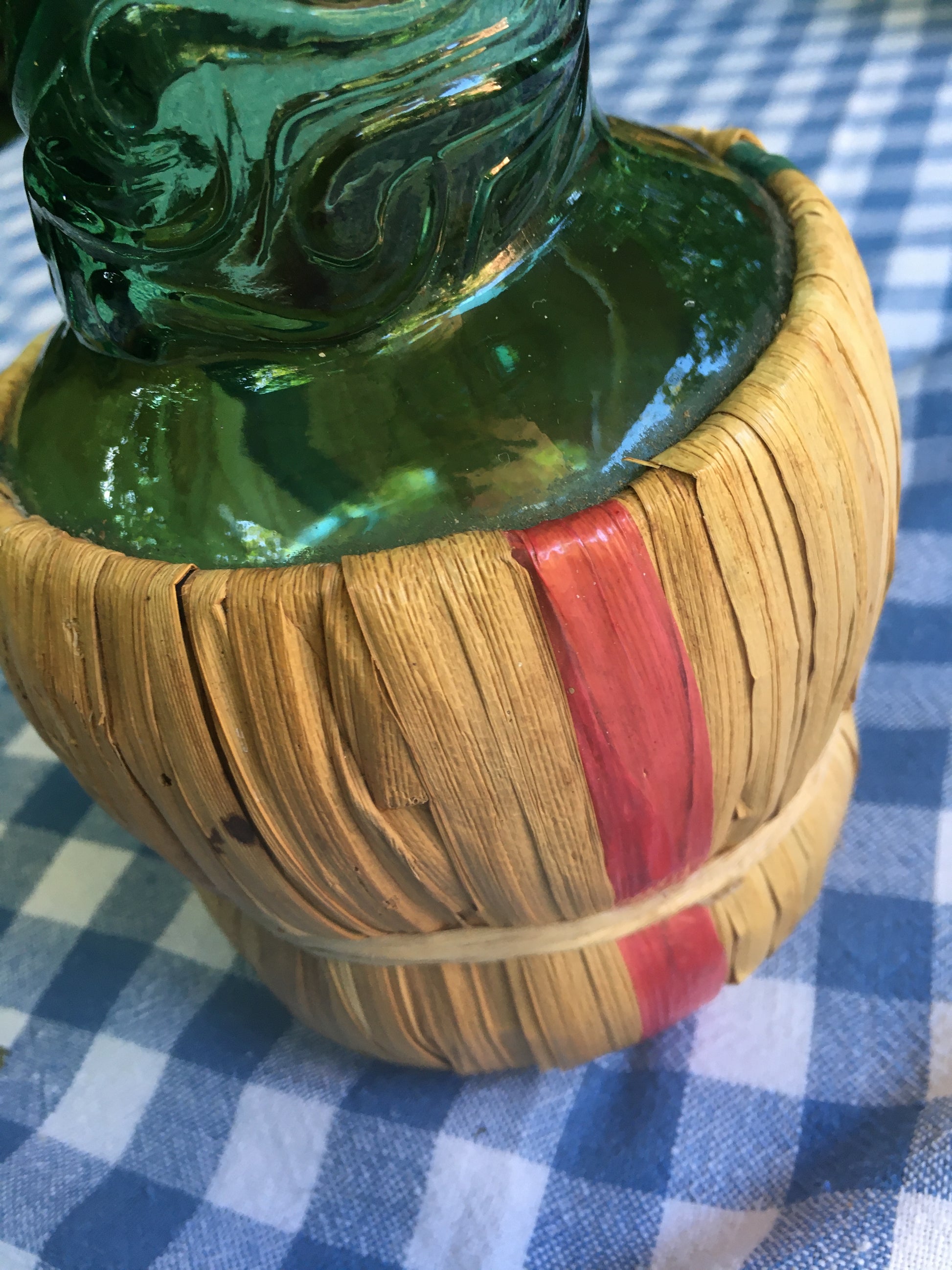 Empoli Genie Bottle, Chianti wicker glass flask, A beautiful Italian vintage wine decanter from the 1950s-60s. Emerald green glass and a spiraling floral embossing along the bottle's convoluted profile.  true find