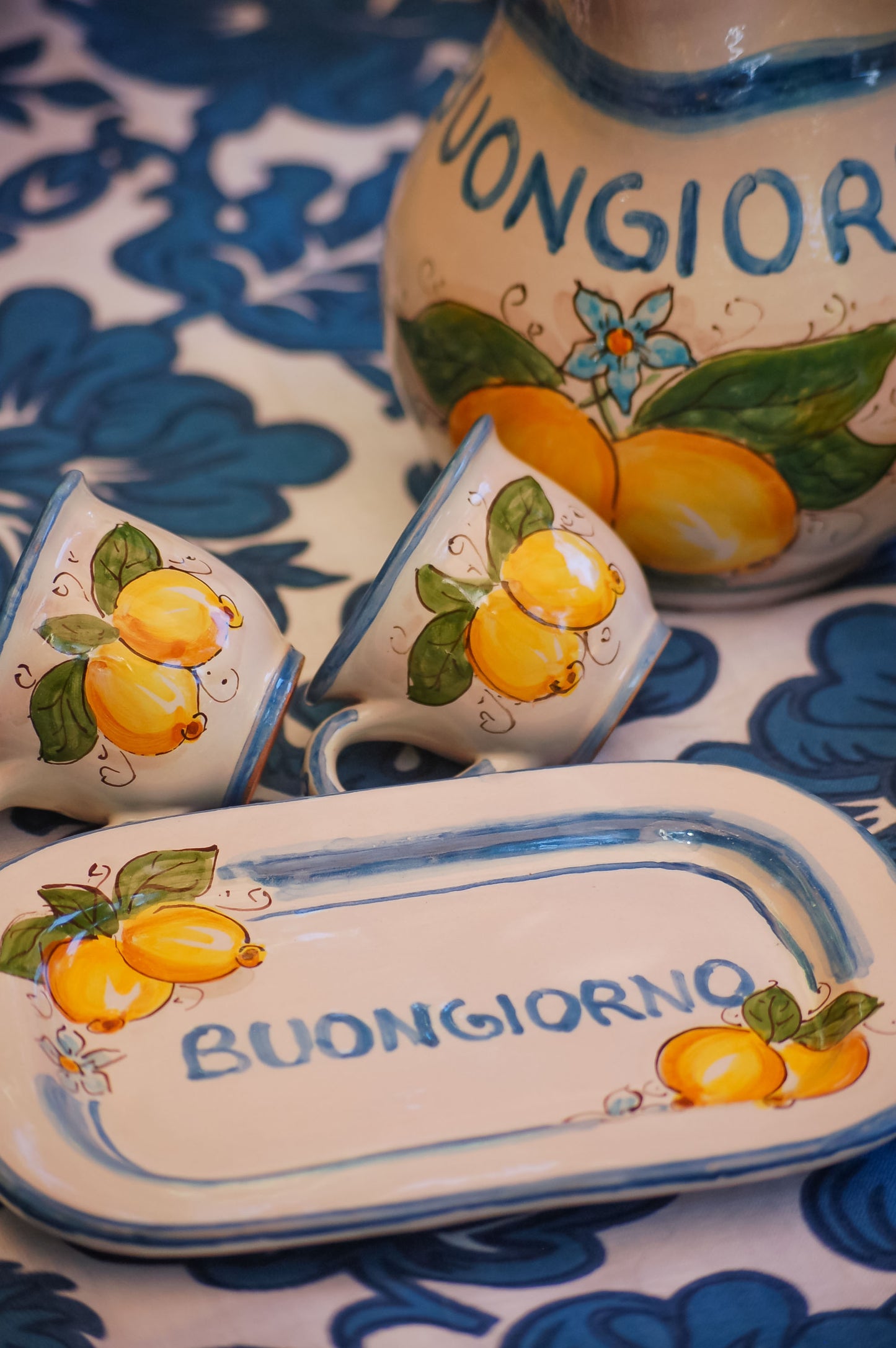 Italian ceramic breakfast set made up of two espresso cups with a tray, and wo bowls. All decorated with light marine blue stripes and vibrant hand painted Amalfi Coast lemons. The tray has the tex: "La vita e' piu bella con te" (life is more beautiful with you) or "Buongiorno" Artisan-made on the island of Sicily