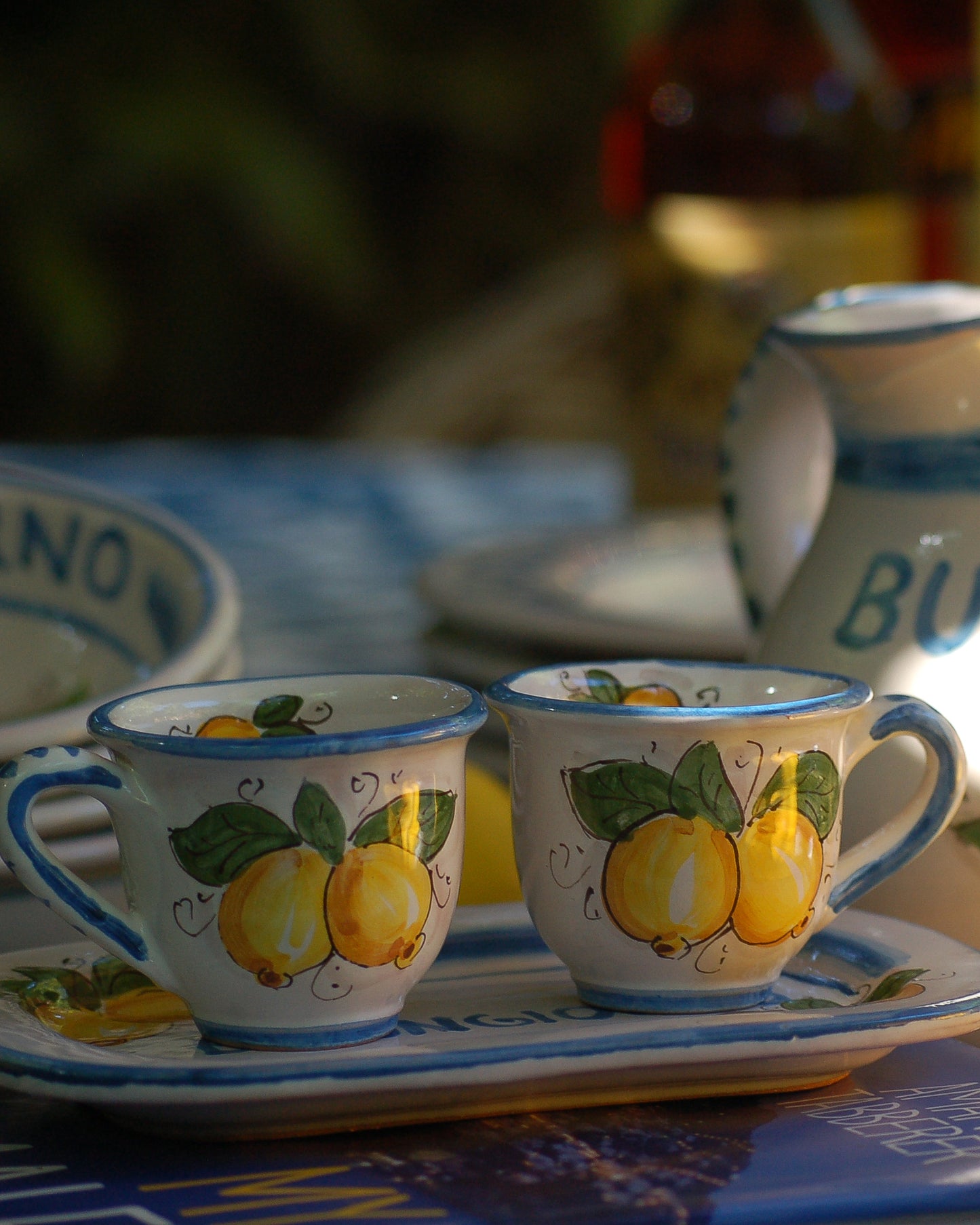 Italian ceramic breakfast set made up of two espresso cups with a tray, and wo bowls. All decorated with light marine blue stripes and vibrant hand painted Amalfi Coast lemons. The tray has the tex: "La vita e' piu bella con te" (life is more beautiful with you) Artisan-made on the island of Sicily