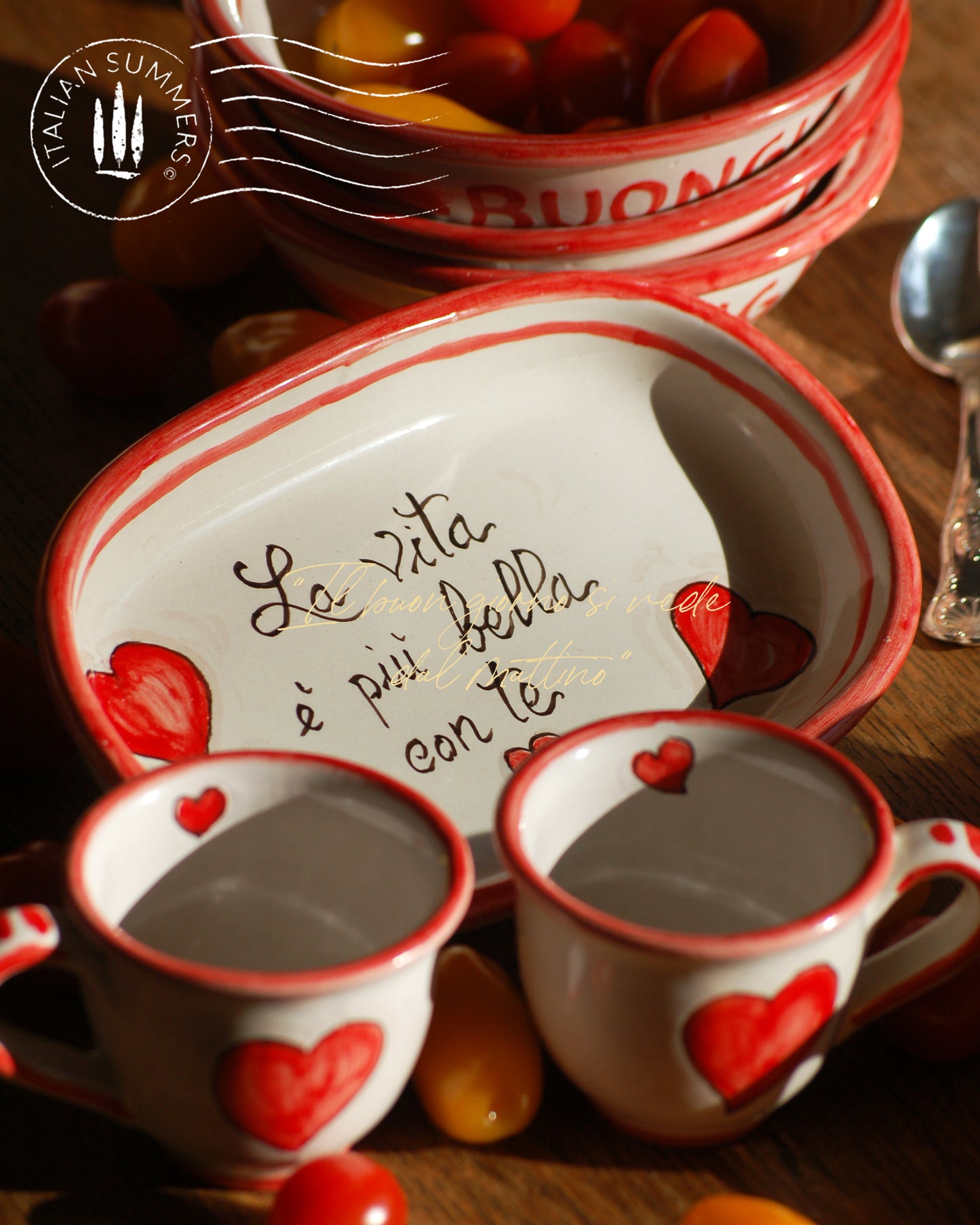 A bright and colorful Italian Maiolica ceramic espresso coffee set, two demitasse and a serving tray featuring happy Sicilian red hearts and a decoration with the Italian text -La vita e' piu bella con te-. hand made in Sicily
