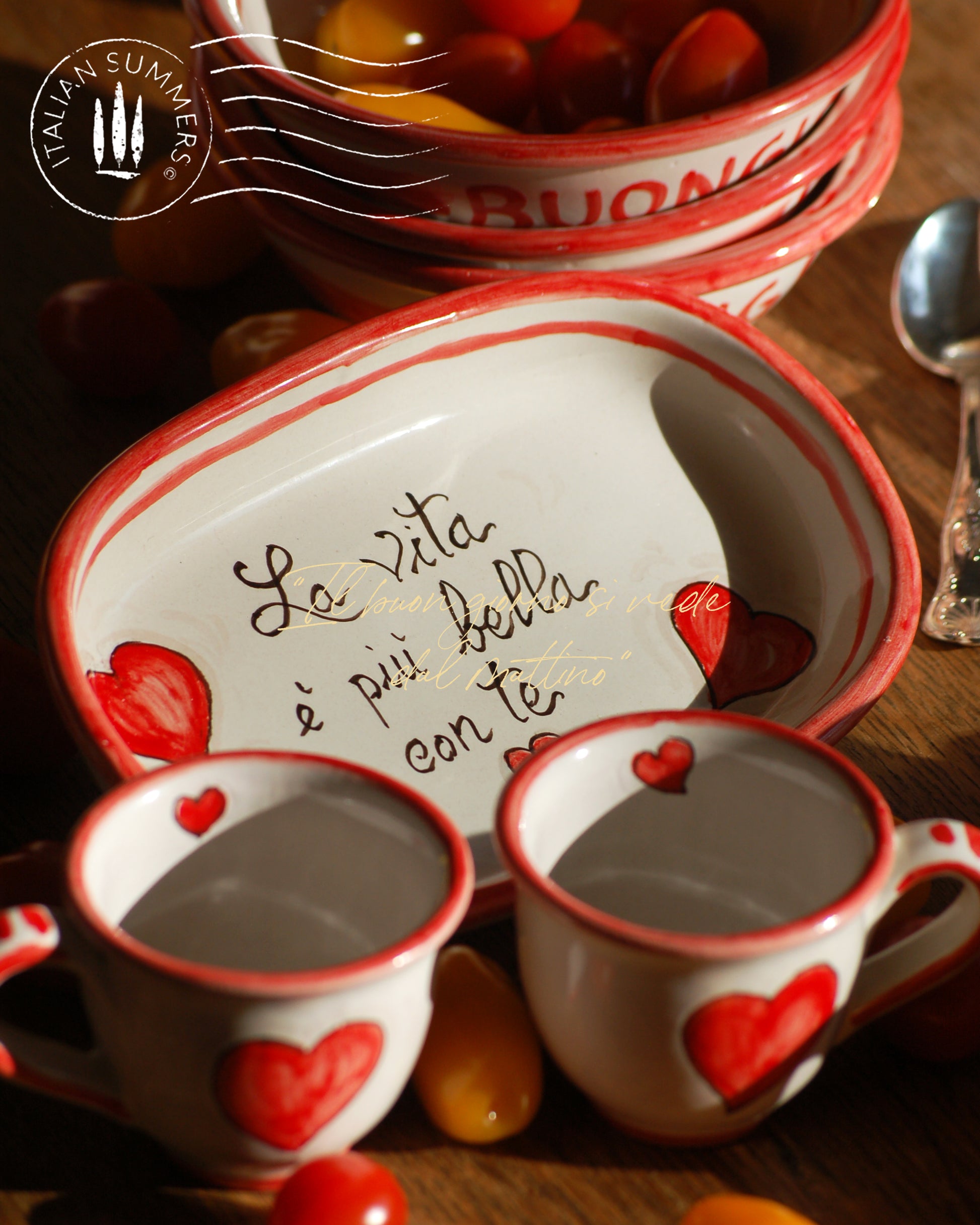 A bright and colorful Italian Maiolica ceramic espresso coffee set, two demitasse and a serving tray featuring happy Sicilian red hearts and a decoration with the Italian text -La vita e' piu bella con te-.  hand made in Sicily
