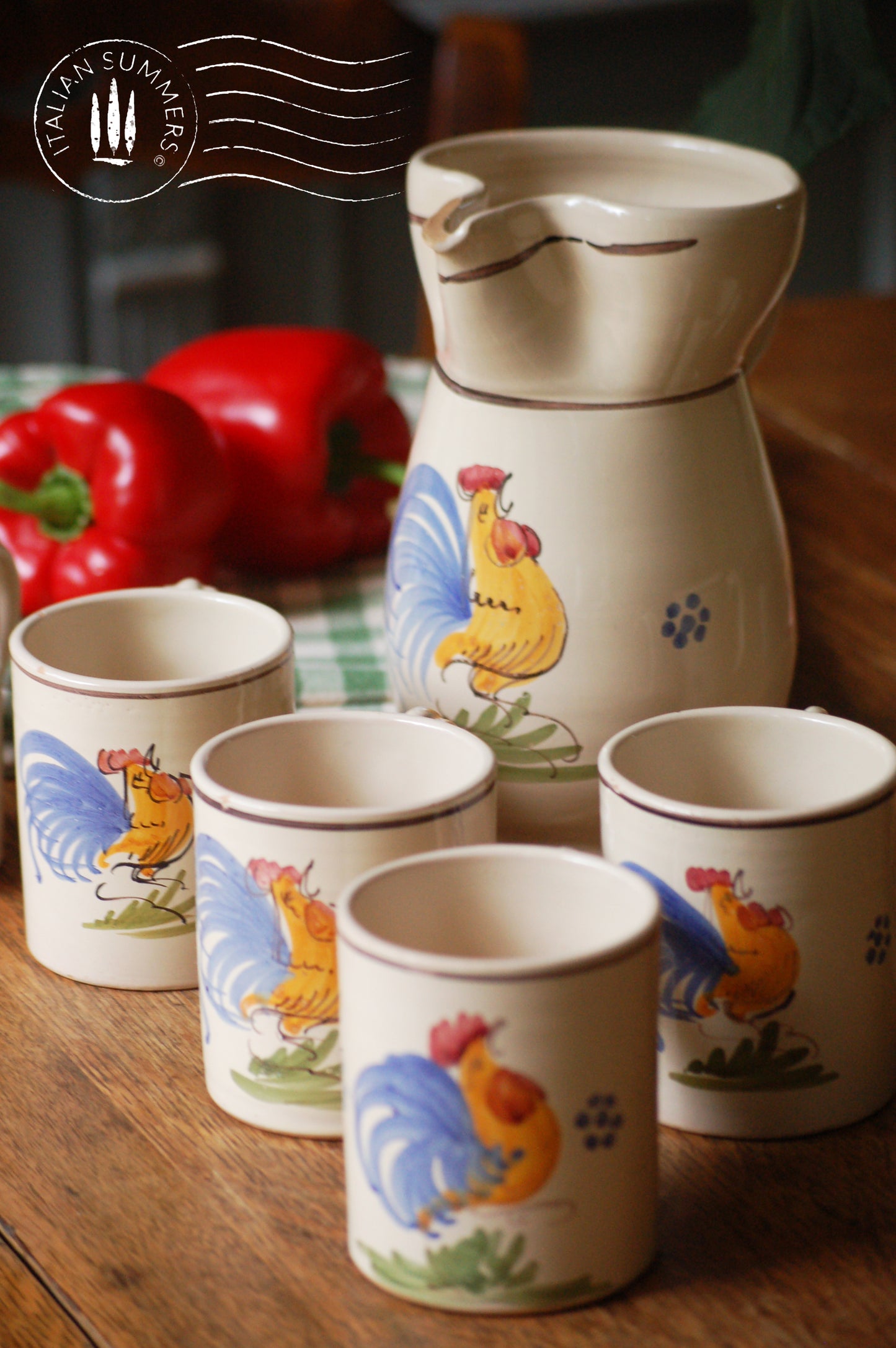 A set of Vintage maiolica ceramic six mugs and a carafe from Puglia, Italy. Each mug as well as the carafe are glazed with the traditional creamy white Grottaglie glaze, decorated with a hand-painted colorful rooster, symbol of good luck and prosperity.