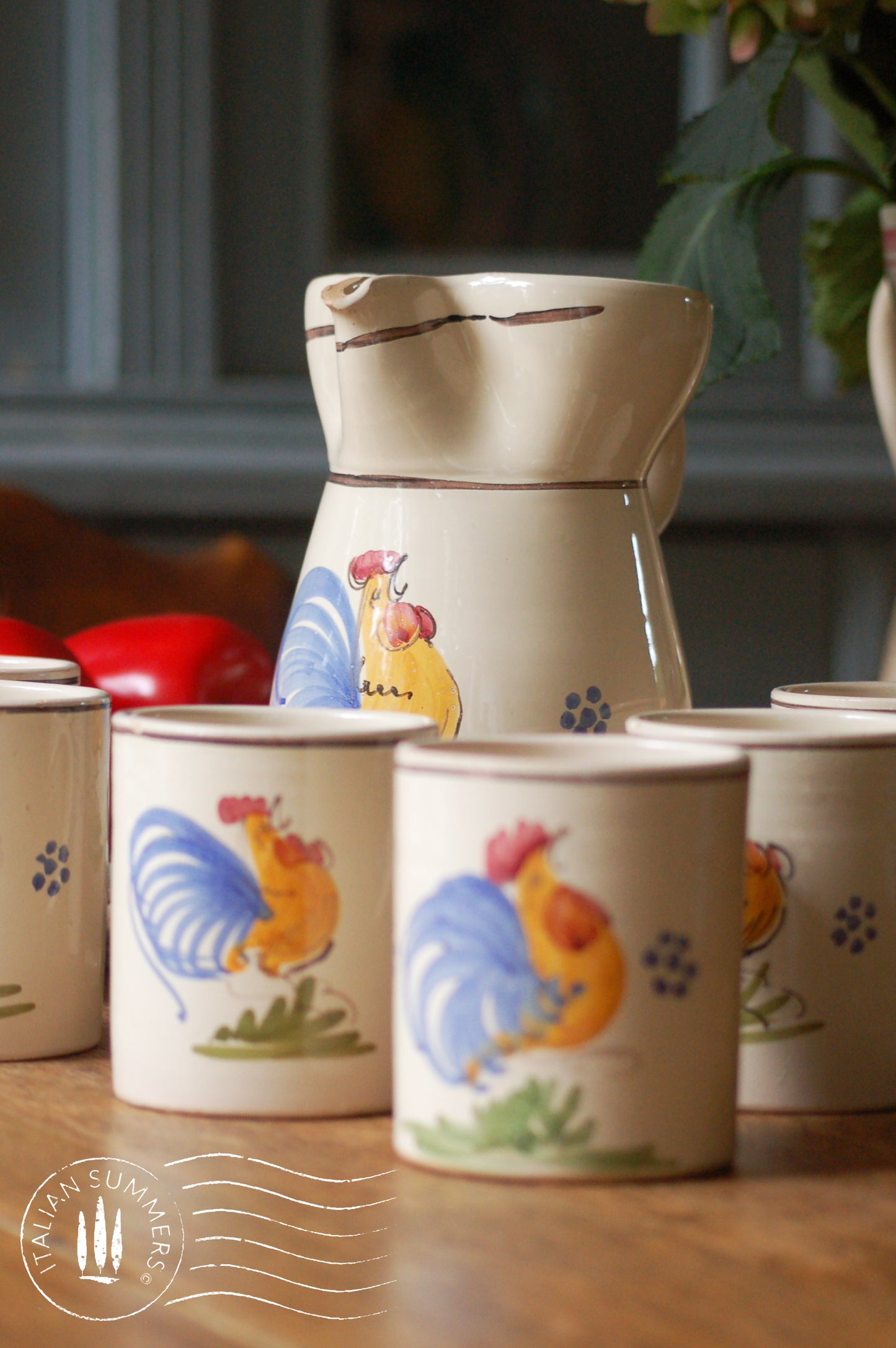 A set of Vintage maiolica ceramic six mugs and a carafe from Puglia, Italy. Each mug as well as the carafe are glazed with the traditional creamy white Grottaglie glaze, decorated with a hand-painted colorful rooster, symbol of good luck and prosperity.