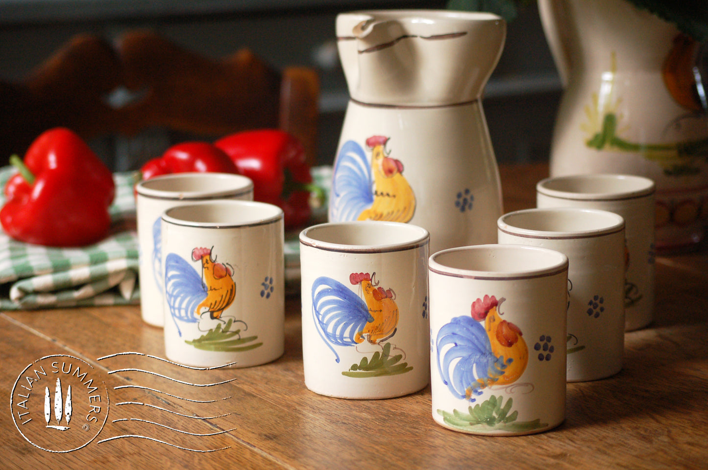 A set of Vintage maiolica ceramic six mugs and a carafe from Puglia, Italy. Each mug as well as the carafe are glazed with the traditional creamy white Grottaglie glaze, decorated with a hand-painted colorful rooster, symbol of good luck and prosperity.