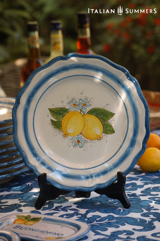 A custom made Italian maiolica ceramic dinner plate decorated with bright Sorrento Lemons and light blue stripes around the scalloped edge and in the  inside of the plate framing the lemons.