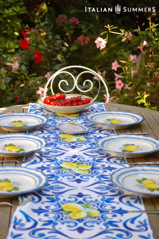 A custom made Italian maiolica ceramic dinner plate decorated with bright Sorrento Lemons and light blue stripes around the scalloped edge and in the  inside of the plate framing the lemons.