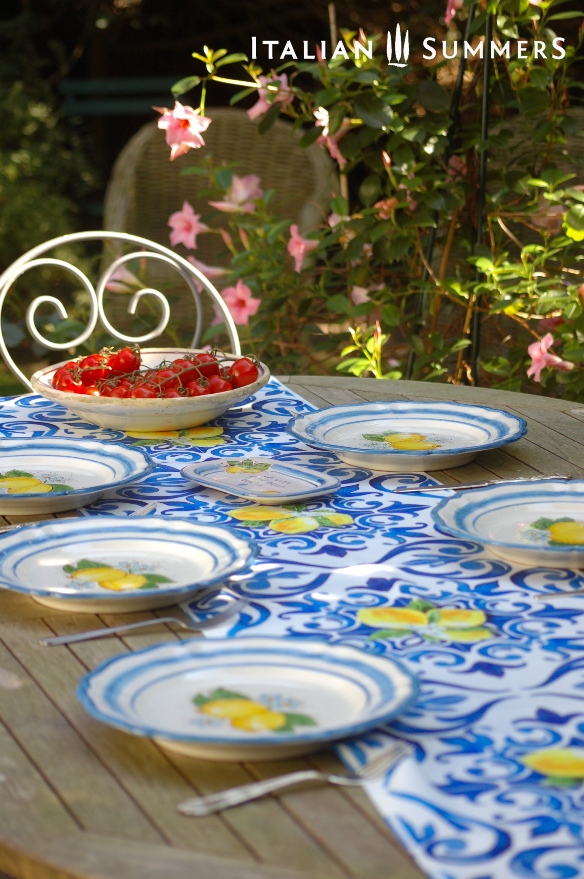 A custom made Italian maiolica ceramic dinner plate decorated with bright Sorrento Lemons and light blue stripes around the scalloped edge and in the  inside of the plate framing the lemons.