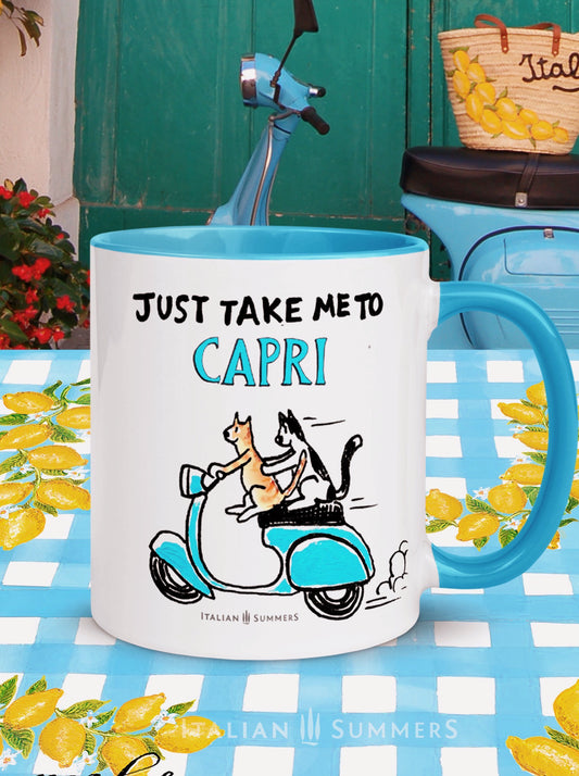 An Italy inspired coffe mug with the text Just take me to Capri. With a sketch of two cats driving an aqua blue vintage Vespa. The mug is avai;able in white or with a yellow or blue inside/handle. Made by Italian Summers