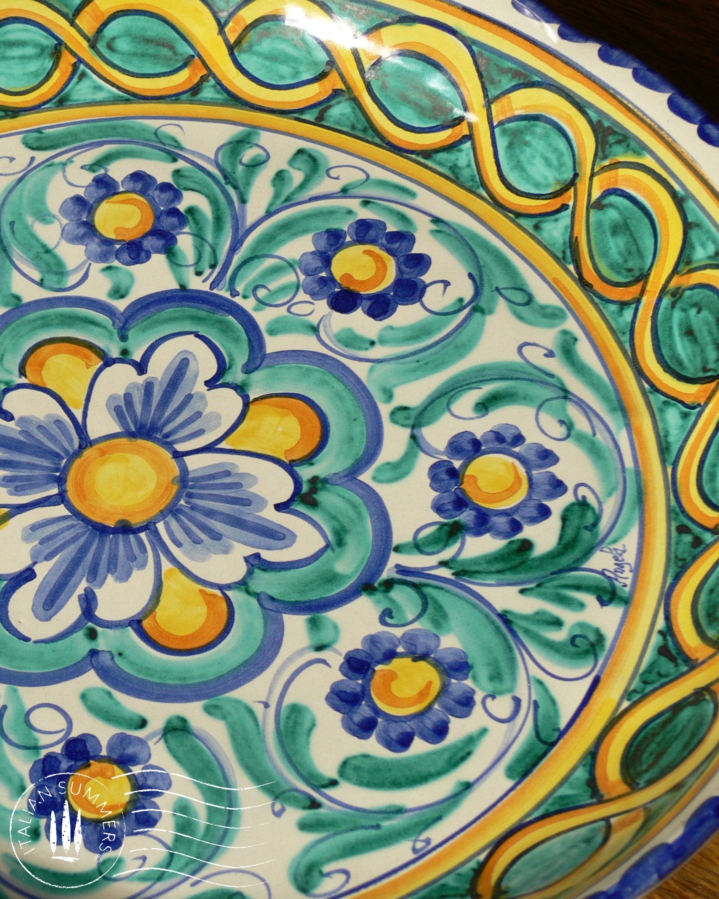A large Siciian Maiolica ceramic platter decorated with rich traditional turquoise and cobalt and yellow glazed colors in the traditional Caltagirone style