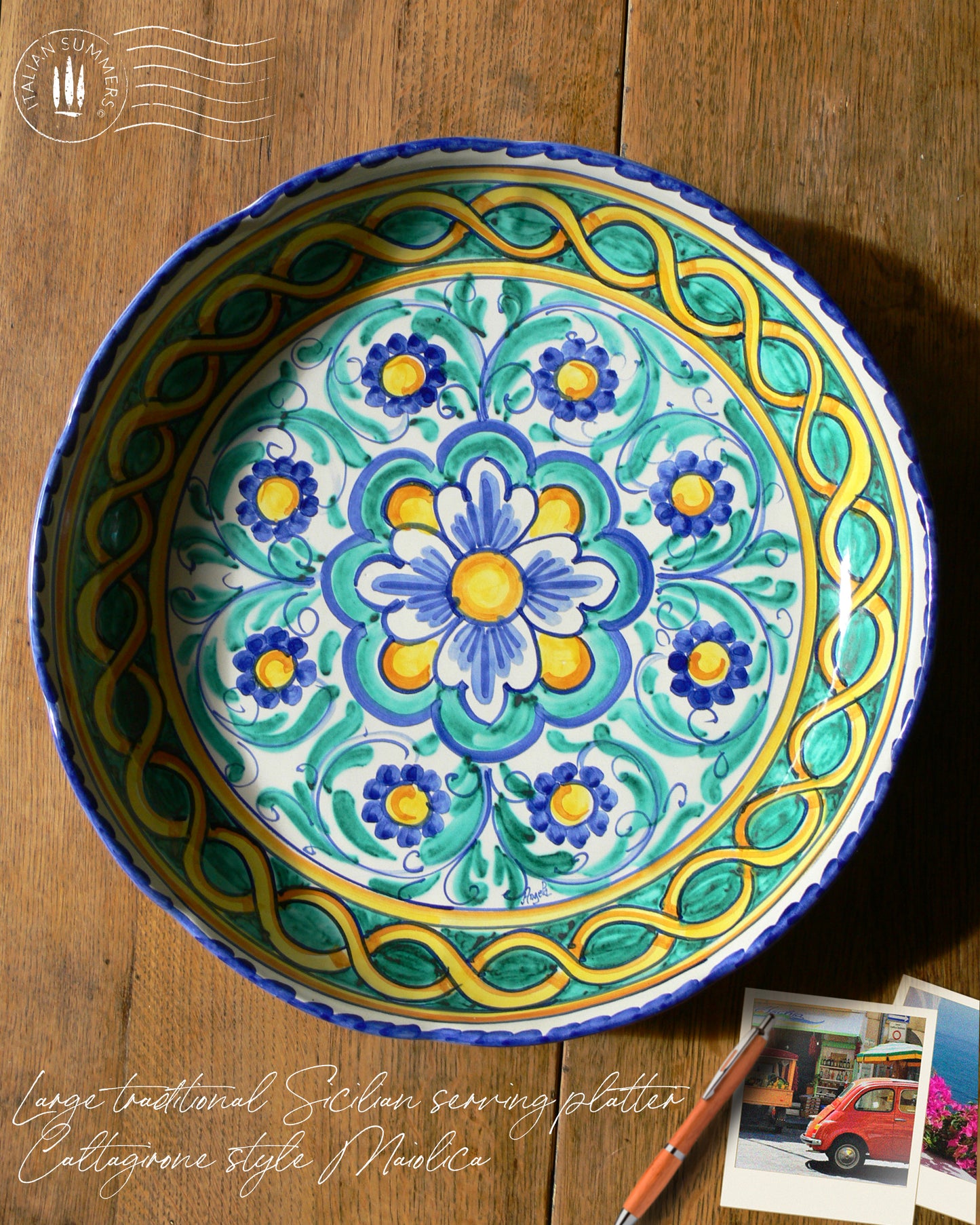 A large Siciian Maiolica ceramic platter decorated with rich traditional turquoise and cobalt and yellow glazed colors in the traditional Caltagirone style