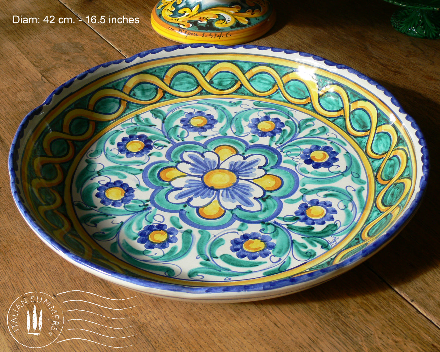 A large Siciian Maiolica ceramic platter decorated with rich traditional turquoise and cobalt and yellow glazed colors in the traditional Caltagirone style