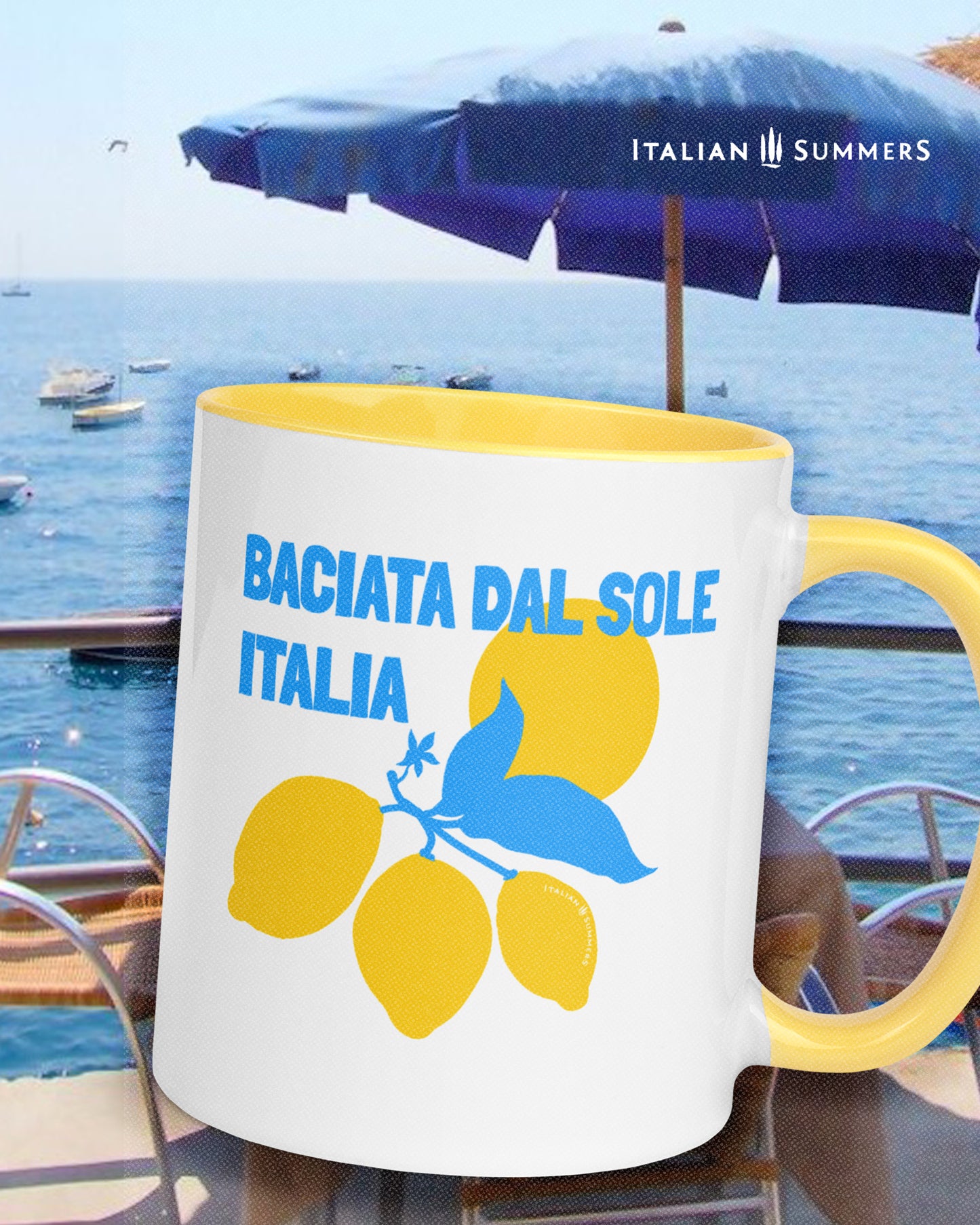 Italian inspired mug with the text Baciata dal Sole with the word Italian under it. Freaturing a stylized with Amalfi coast lemons and the sun. Available whith a blue or a yellow insidean handle. Designed and sold by Italian  Summers
