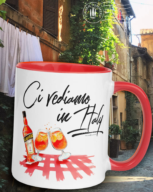 Mug "Ci vediamo in Italy" by Italian Summers! It represents a colorful sketch of a checkered tablecloth with a bottle and glasses of Aperol Spritz which gives you the Italian osteria vibes.  And the quote Ci vediamo in Italy which means 'See you in Italy" Available in red, pink,, orange. By Italian Summers
