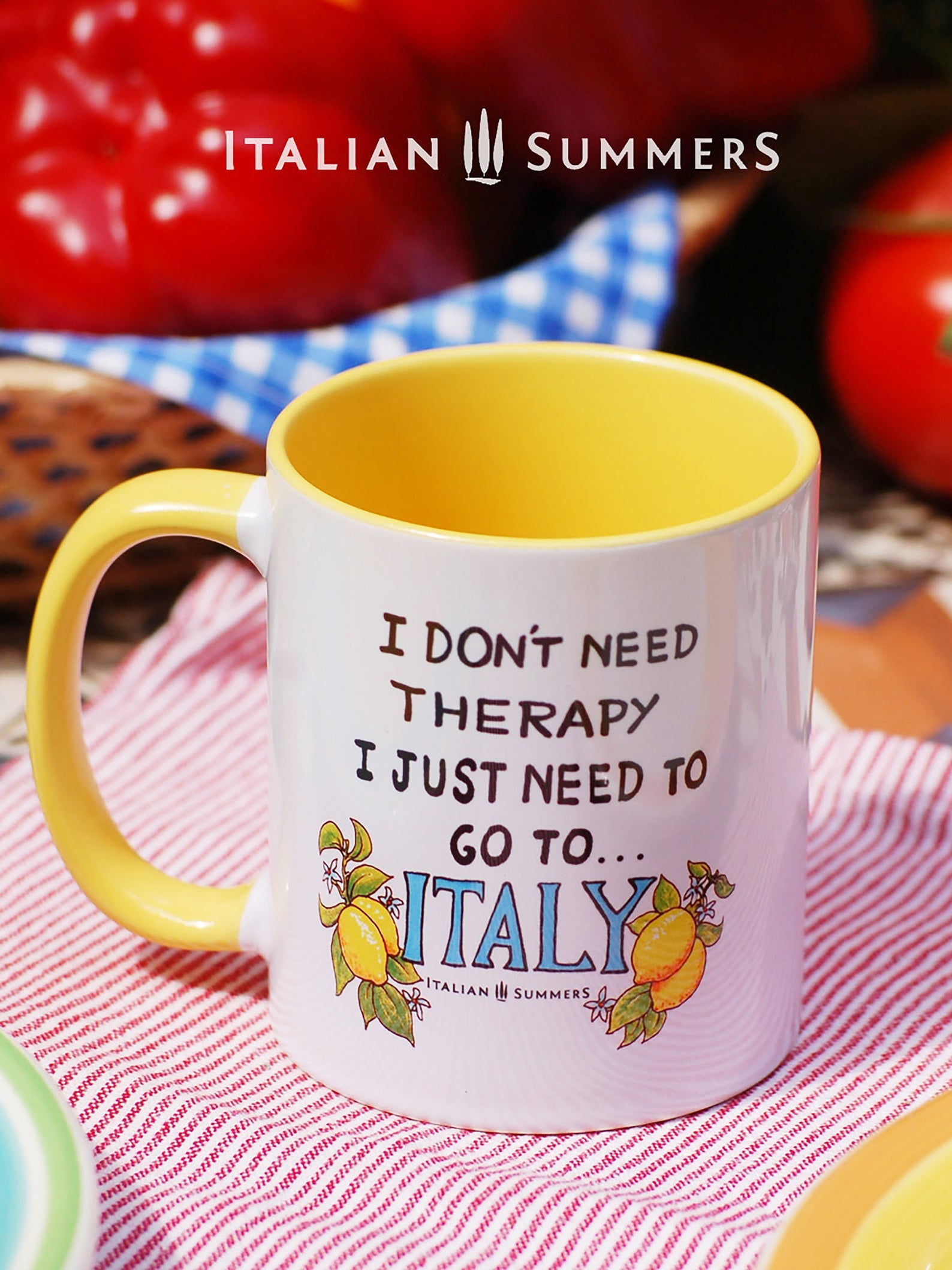Italy inspired mug with the quote "I don't need therapy, I just need to go to Italy" The word Italy is written in a happy blue color and has 2 lemons on every side. The mug is printed on 2 sides and is available with colored inside/handle in blue yellow and pink