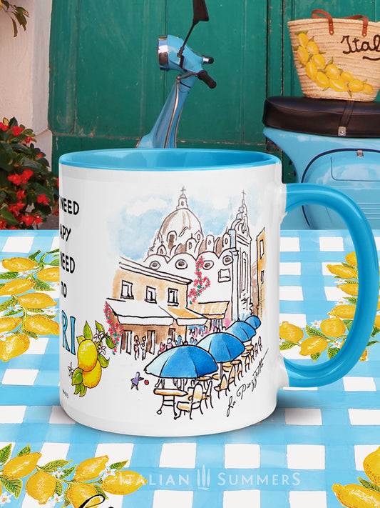 Italy-inspired white ceramic mug with blue colored handle and interior. Printed with a drawing of Capri's Piazzetta  with blue cafe Umbrellas and a crowd of shoppers strolling. The quote: I don't need therapy I just need to go to Capri is present . The word Italy is in blue Capital letters and flanked by bunches of Sorrento lemons with flowers. Made by Italian Summers