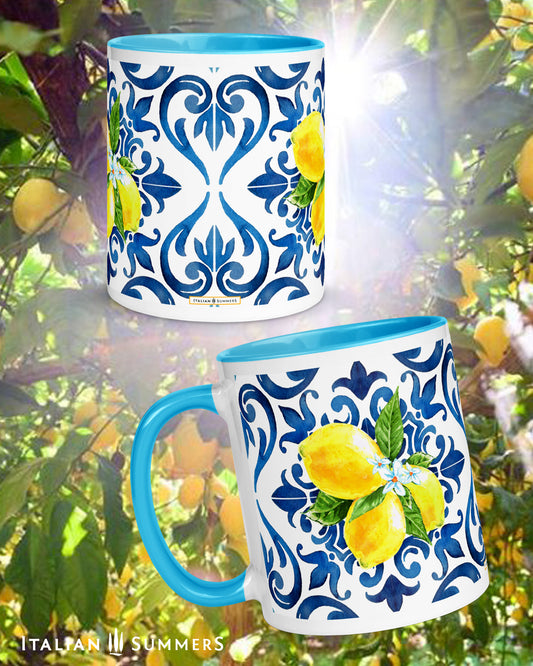 Italy inspired white ceramic mug with blue hande and interior. Italian blue tile pattern printed on the outside with bunches of sunny Sorrento lemons with flowers . Made by Italian Summers