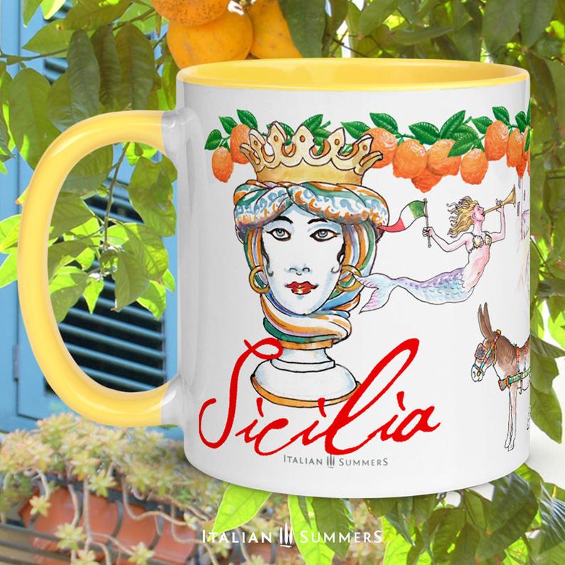Sicily inspired mug with sketches of the seaside town Cefalu, a trinacria, a Sicilian caretto with of course a cute little donkey , a moore head and a mermaid. On the rim there is a garland of Sicilian oranges. Sicilia is written on the mug in a red handwriting