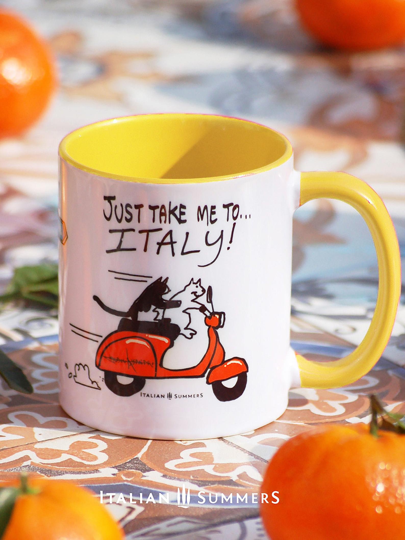 Italy inspired mug with a sketch of 2 cats driving on a vintage orange Vespa, with the quote "Just take me to Italy'. In the center of the mug is a sketch of a streetsign with the locations Positano and Tuscany. Made by Italian Summers