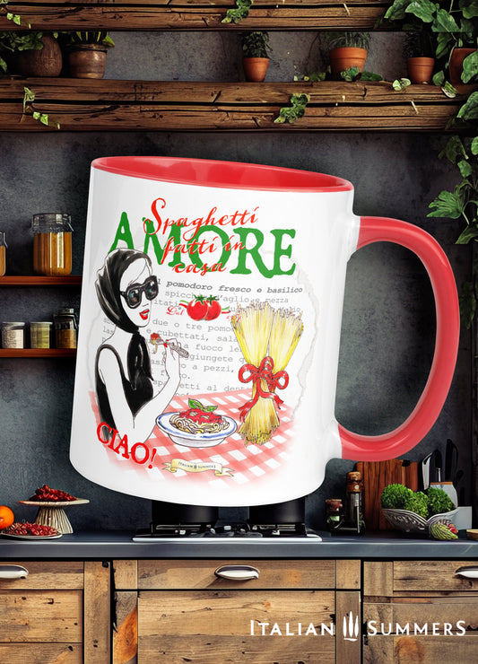 Italy theme mug Viva la pasta is a white ceramic mug with red handle and inside color, it features a drawing of a blonde woman in a black summer dress, black oversize sunglasses and a black headscarf in the style of the 1960s, as she is eating a forkful from a bowl of spaghetti placed on a red-checkered tablecloth.
The text on the mug states: Spaghetti Amore. A typed recipe for Spaghetti al pomodoro is visible in the background.