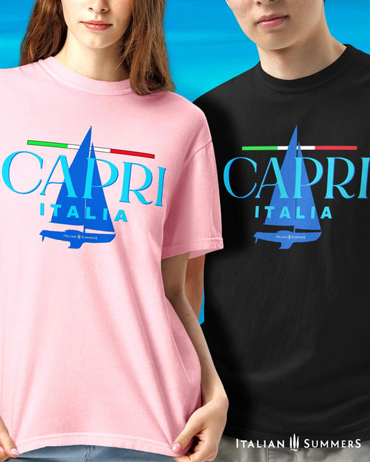 A couple wearing a light pink  and a navy T shirt, with a frontal prints featuring a marine blue silhouette of a sailboat and a large text: CAPRI, ITALIA, with a thin Italian flag as a chevron, looking like a sailing shirt for sportsmen or Mediterranean Sea enthusiasts.