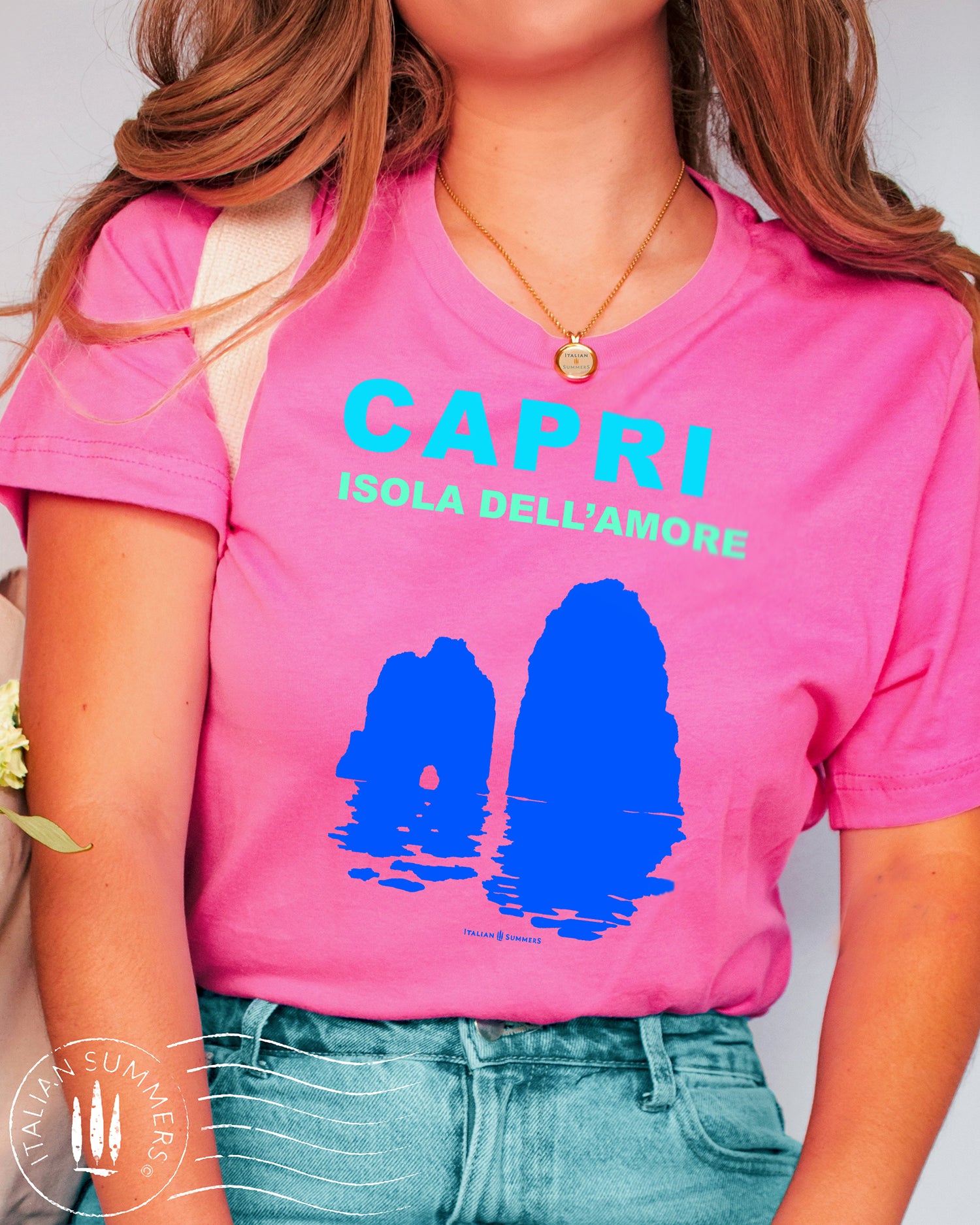 Italy inspired garment dyed T shirt with the aqua and white text: CAPRI, Isola dell'Amore (Capri, Iland of Love) with the silhouette  of the famous Faraglioni and their reflection umpon the waters of the Mediterranean Sea. Made by Italian Summers