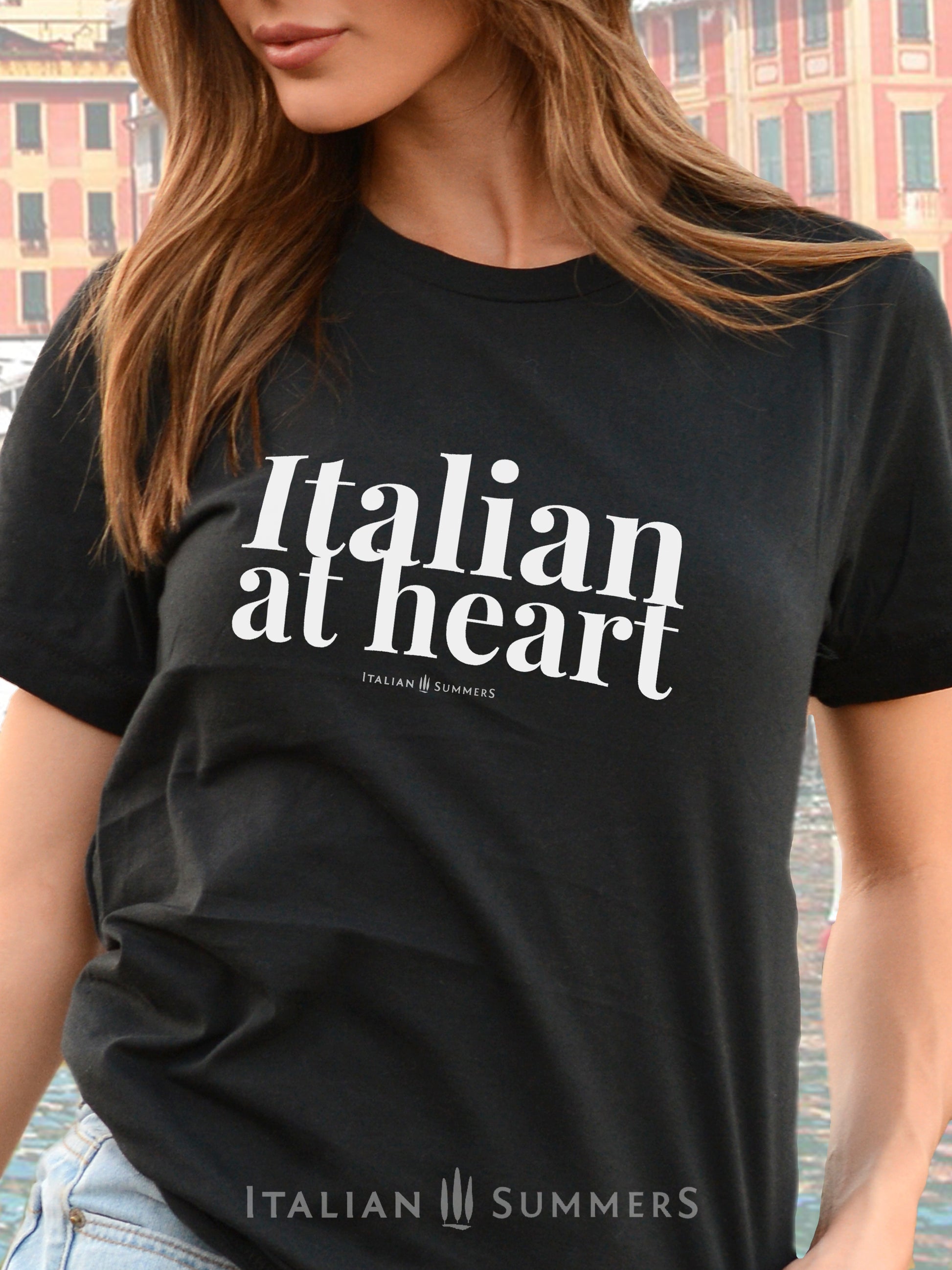 A girl wears a black all cotton t shirt with a retro-style white text print that states: ITALIAN AT HEART