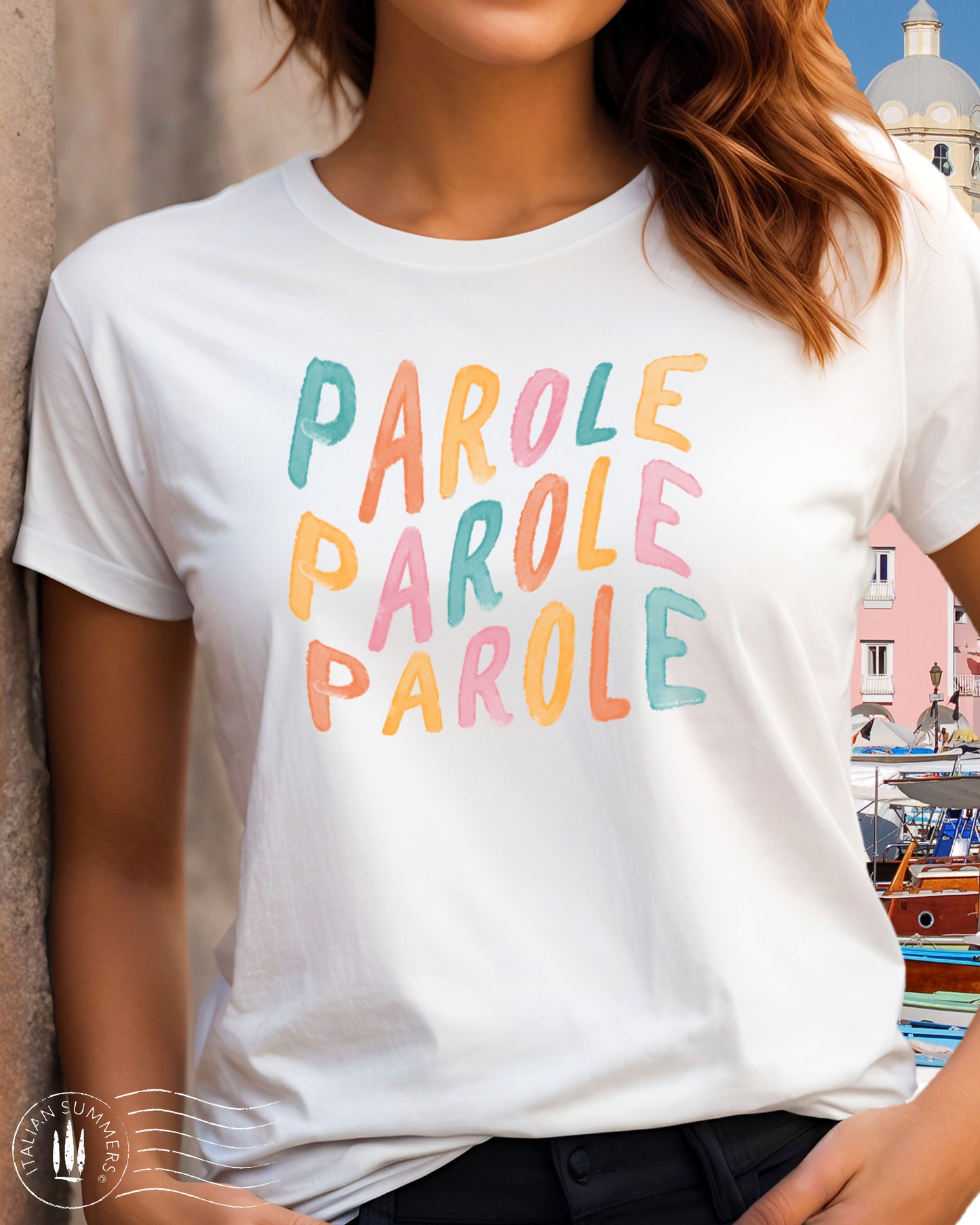 A girl is wearing an all-cotton white t-shirt with a colorful Italian quote in soft pastel tones: 'parole, parole, parole', reminiscent of Mina's famous Fab 70s song. Perfect to evoke that cheerful feeling when you wear it!